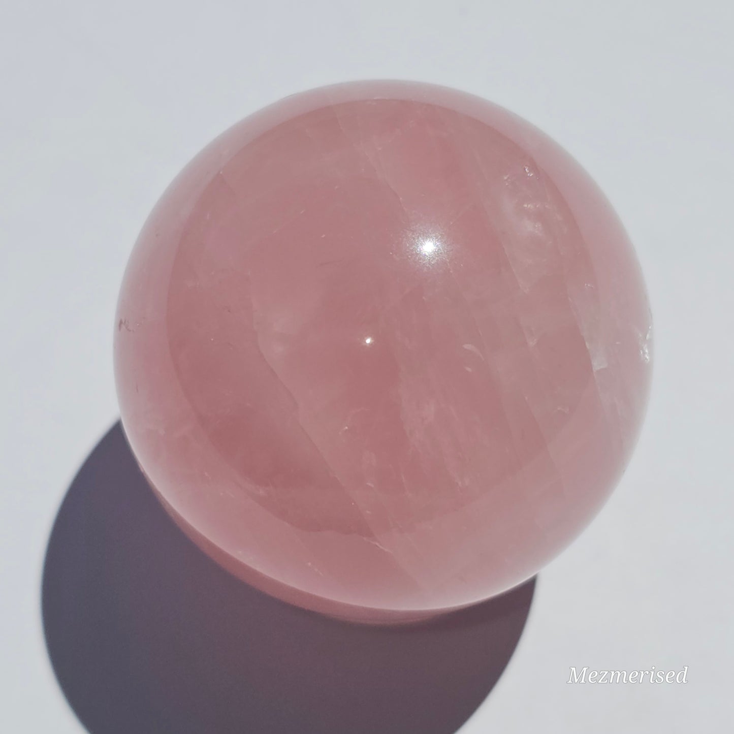 A beautiful Rose Quartz sphere with asterism and gorgeous rainbows