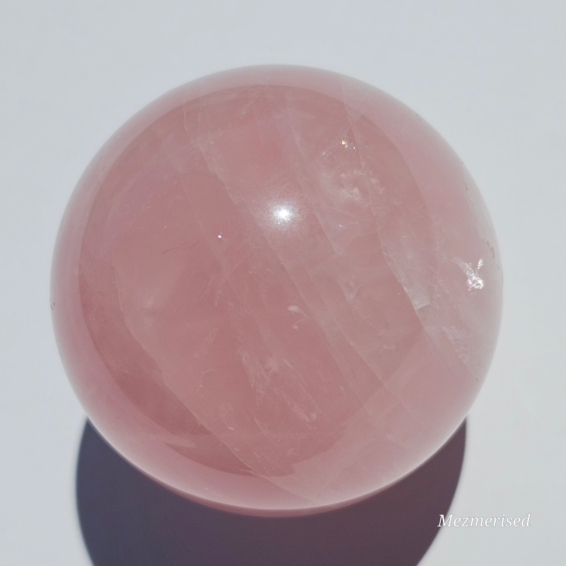 A beautiful Rose Quartz sphere with asterism and gorgeous rainbows