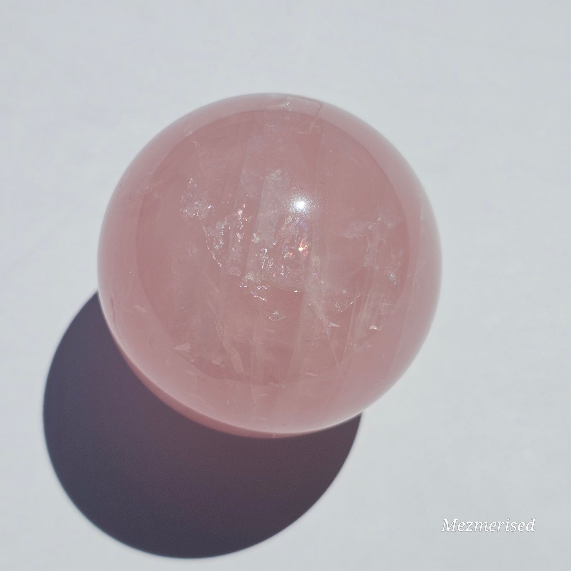 A beautiful Rose Quartz sphere with asterism and gorgeous rainbows