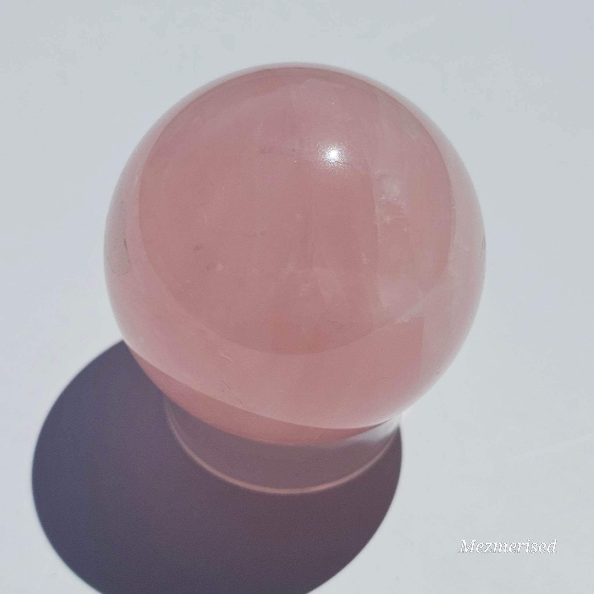 A beautiful Rose Quartz sphere with asterism and gorgeous rainbows