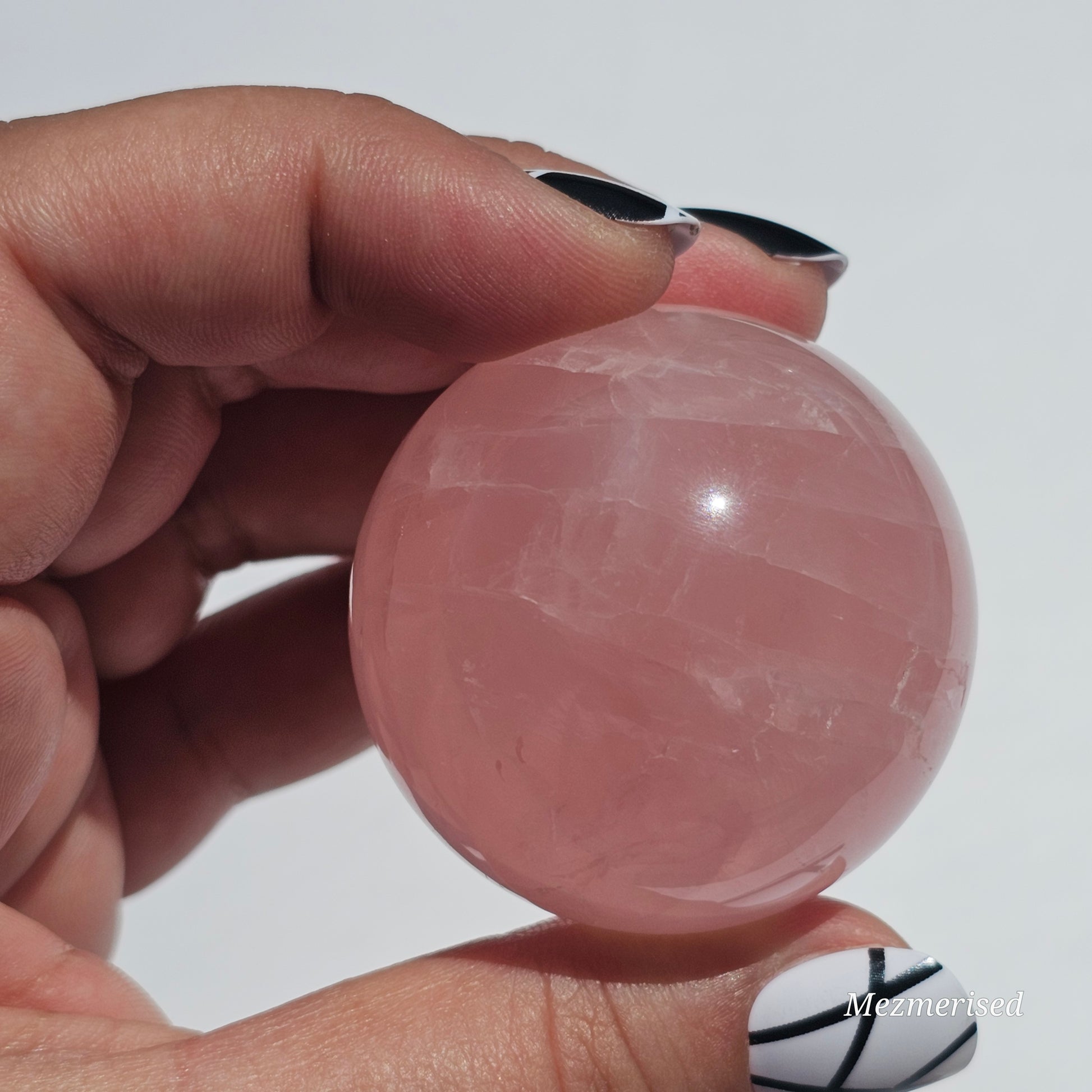 A beautiful Rose Quartz sphere with asterism and gorgeous rainbows