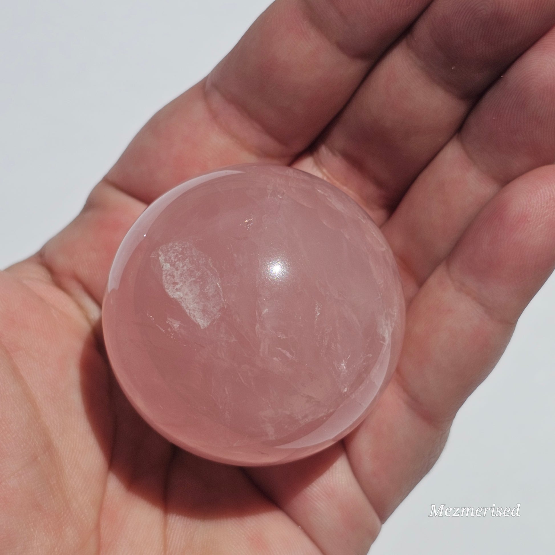 A beautiful Rose Quartz sphere with asterism and gorgeous rainbows