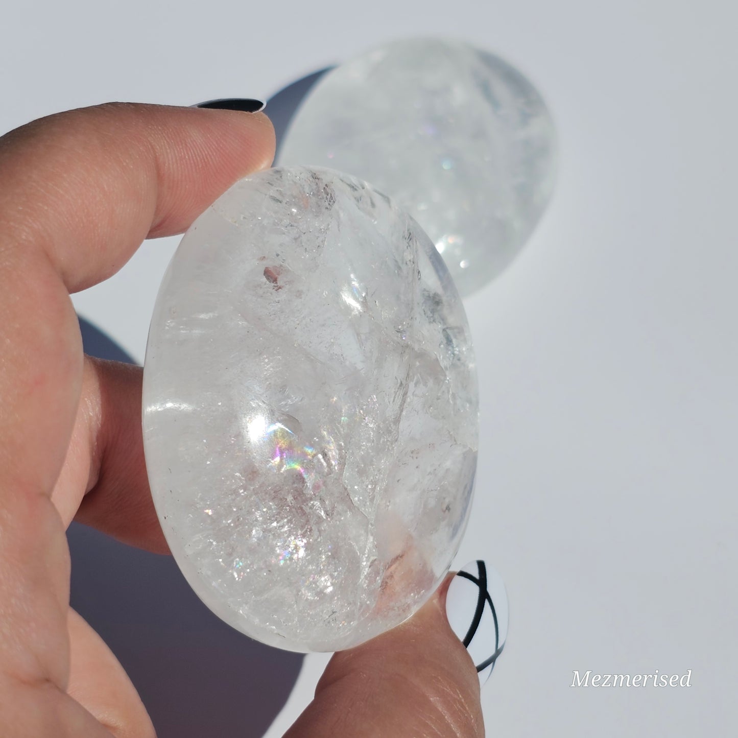 Stunning transparent Clear Quartz palm stones with rainbows.