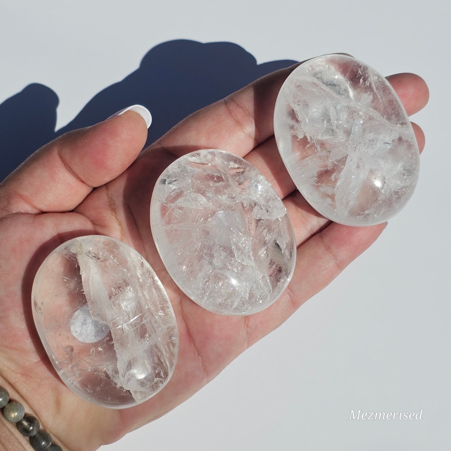 Stunning transparent Clear Quartz palm stones with rainbows.