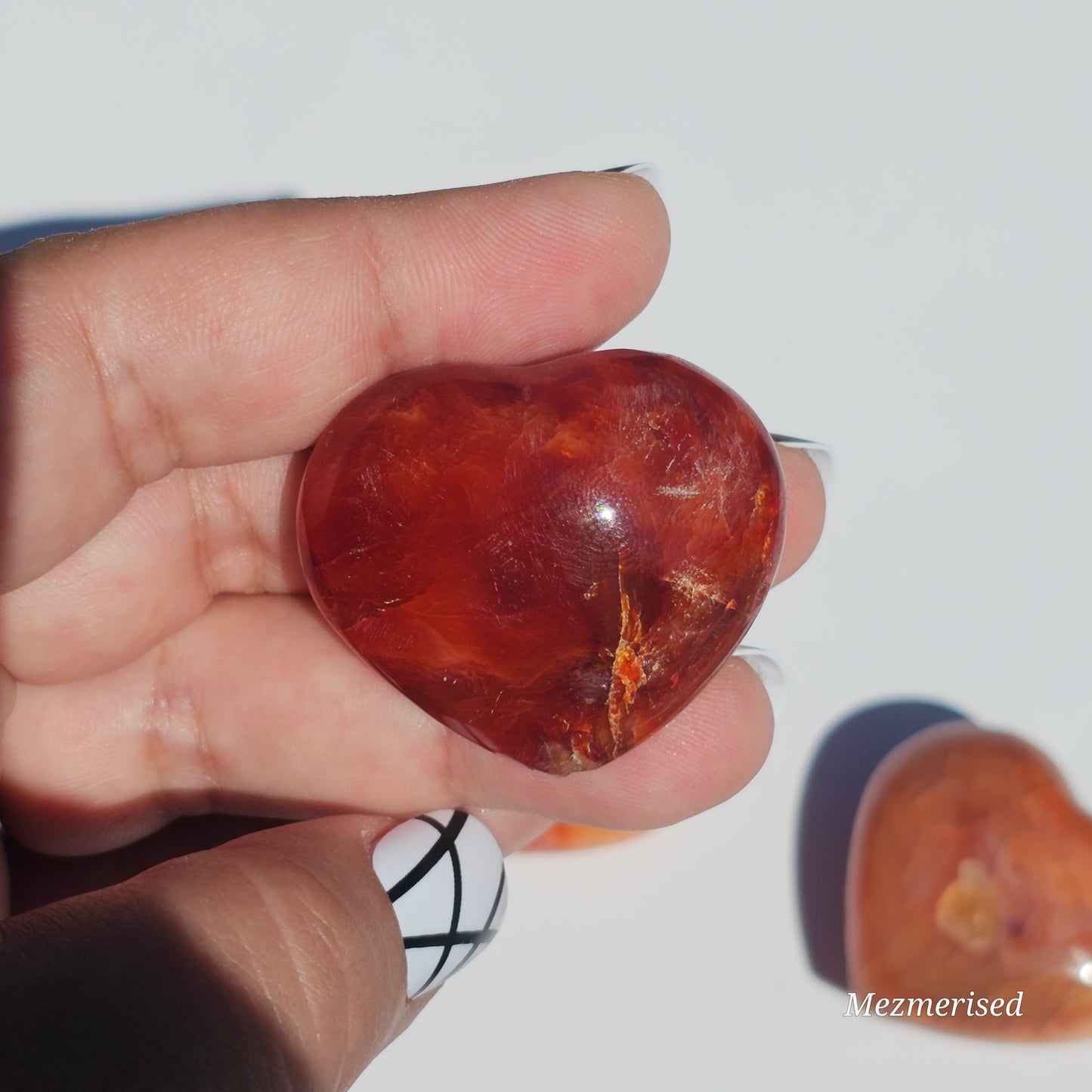 Small beautifully carved puffy Carnelian hearts.