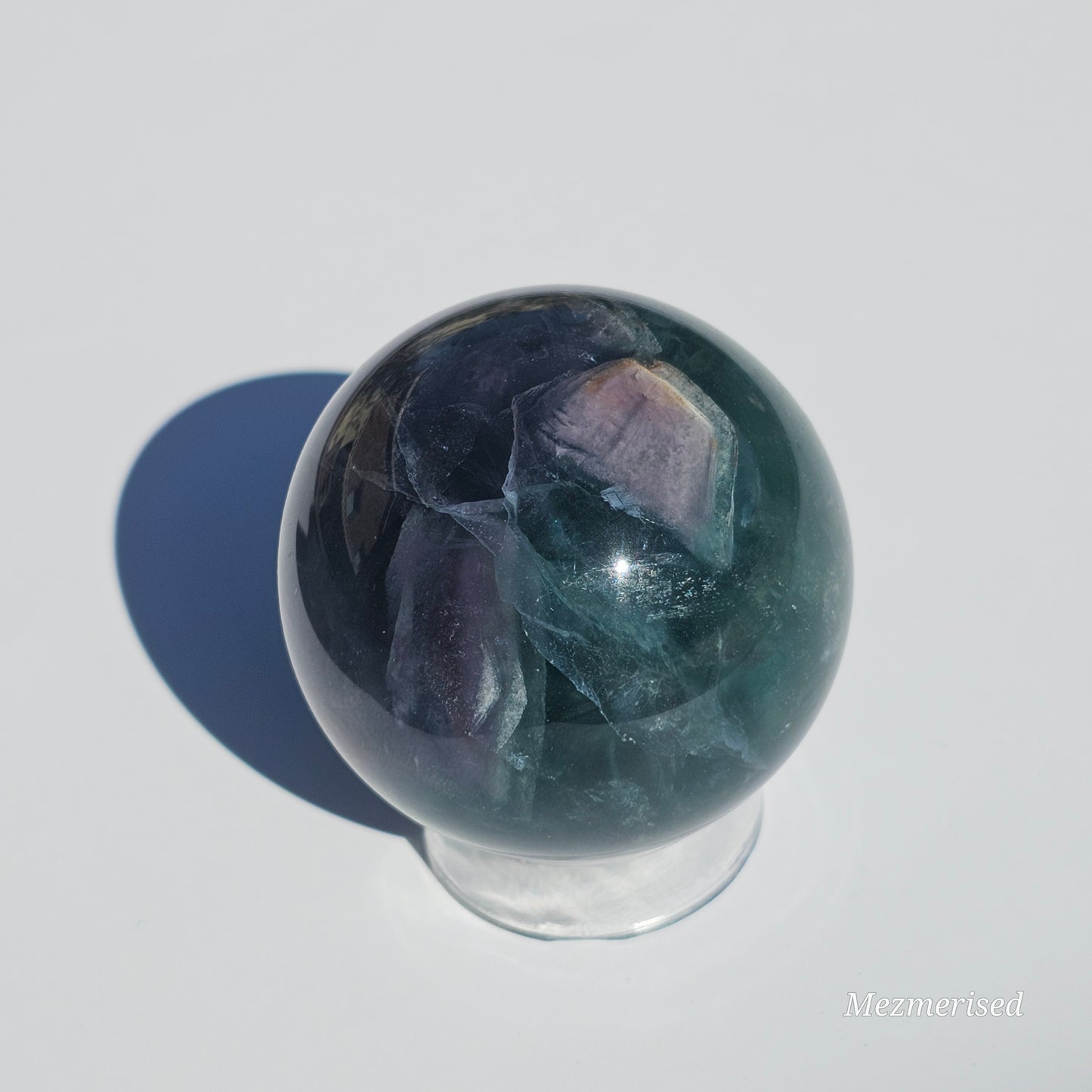 Rich dark forest green Fluorite sphere with beautiful rainbows