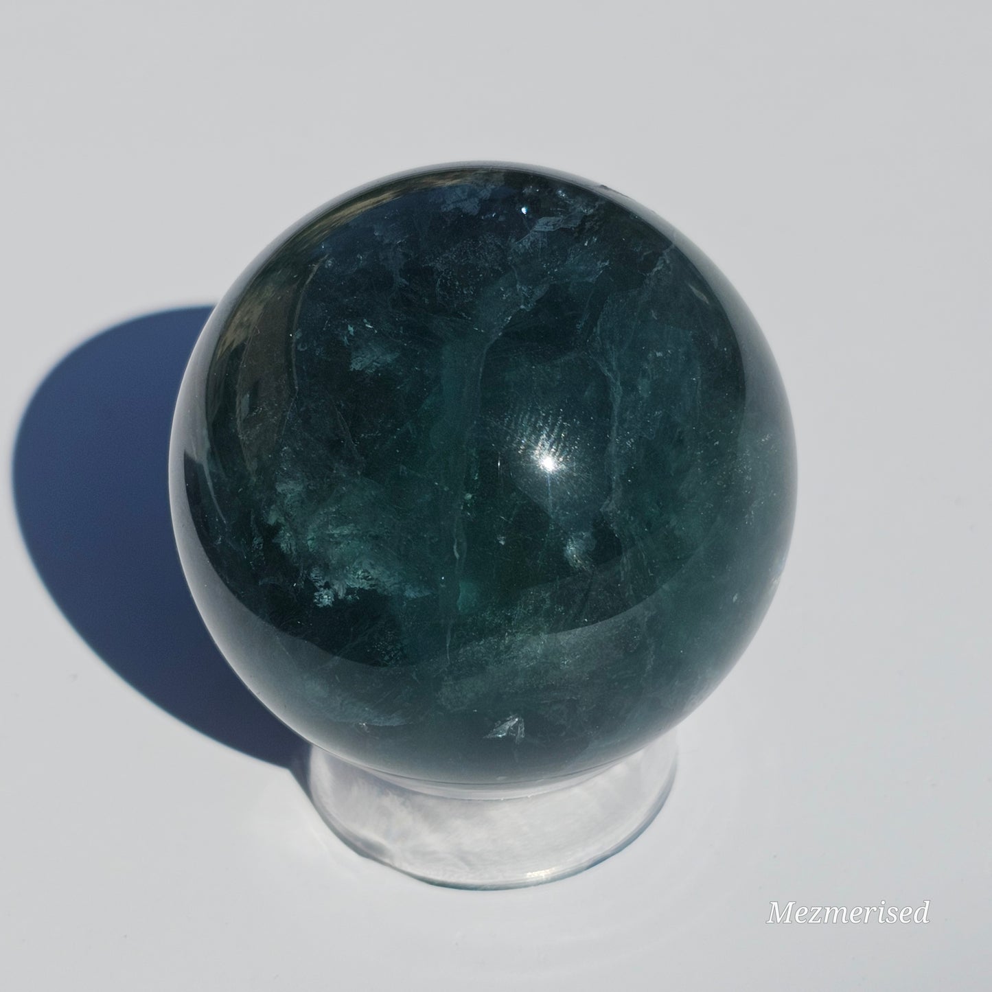 Rich dark forest green Fluorite sphere with beautiful rainbows