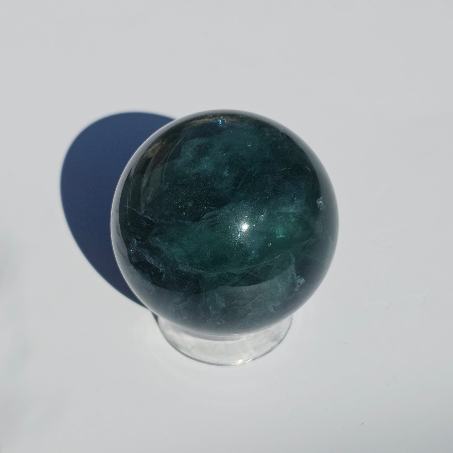 Rich dark forest green Fluorite sphere with beautiful rainbows