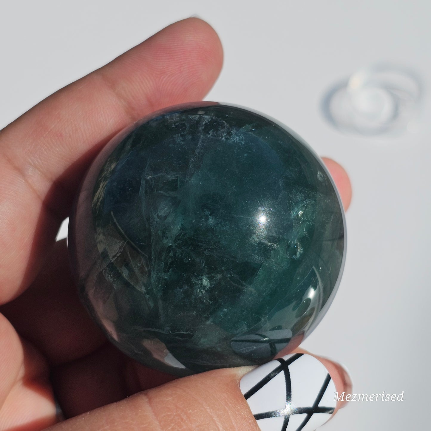 Rich dark forest green Fluorite sphere with beautiful rainbows