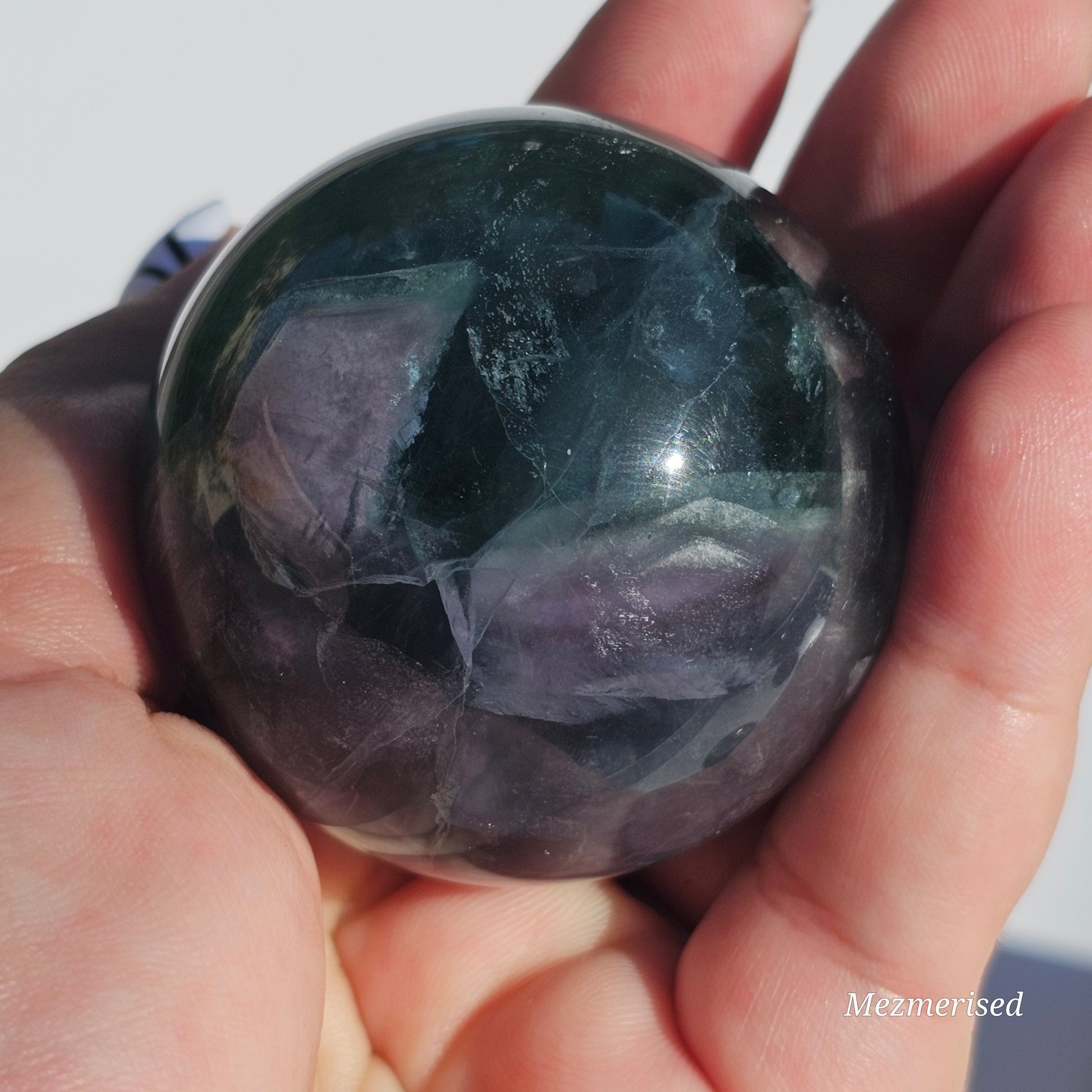 Rich dark forest green Fluorite sphere with beautiful rainbows