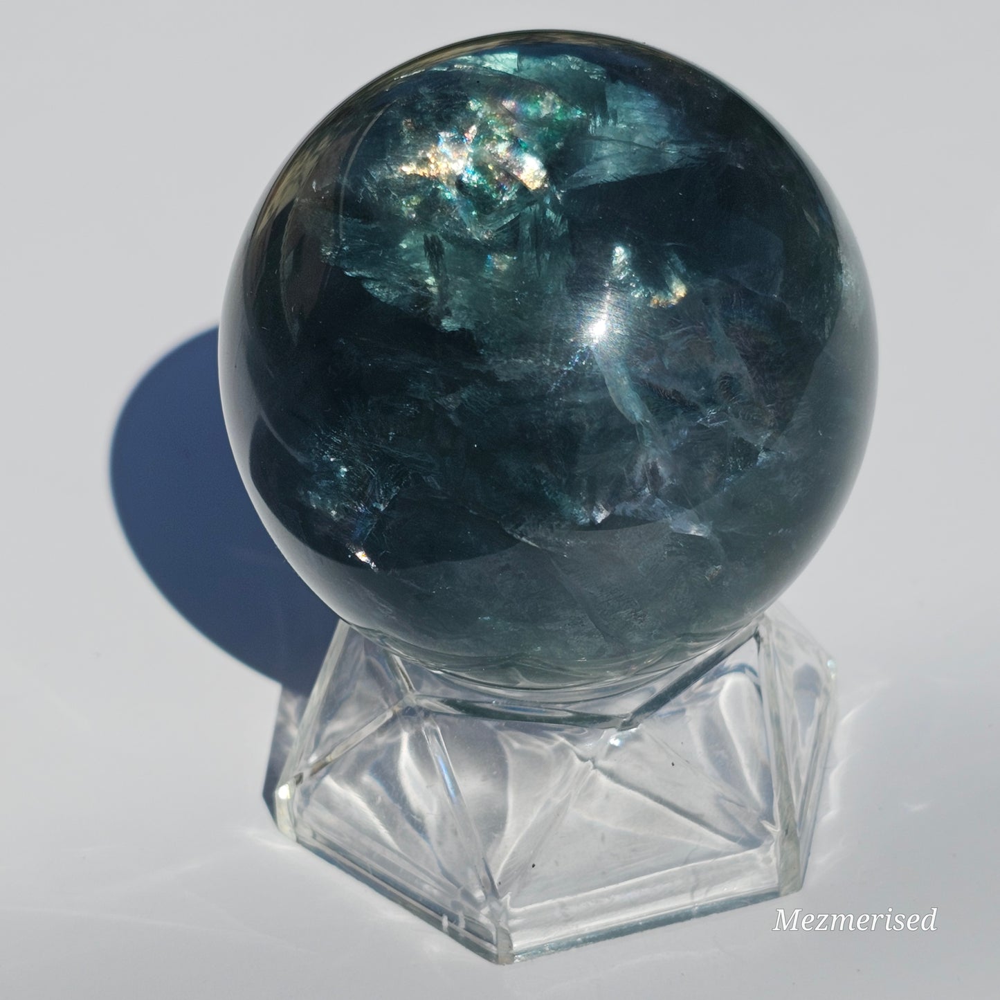 Rich dark forest green Fluorite sphere with beautiful rainbows