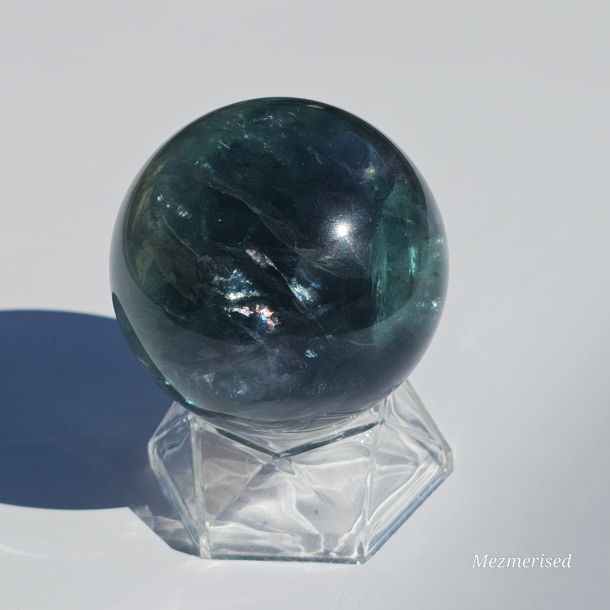 Rich dark forest green Fluorite sphere with beautiful rainbows