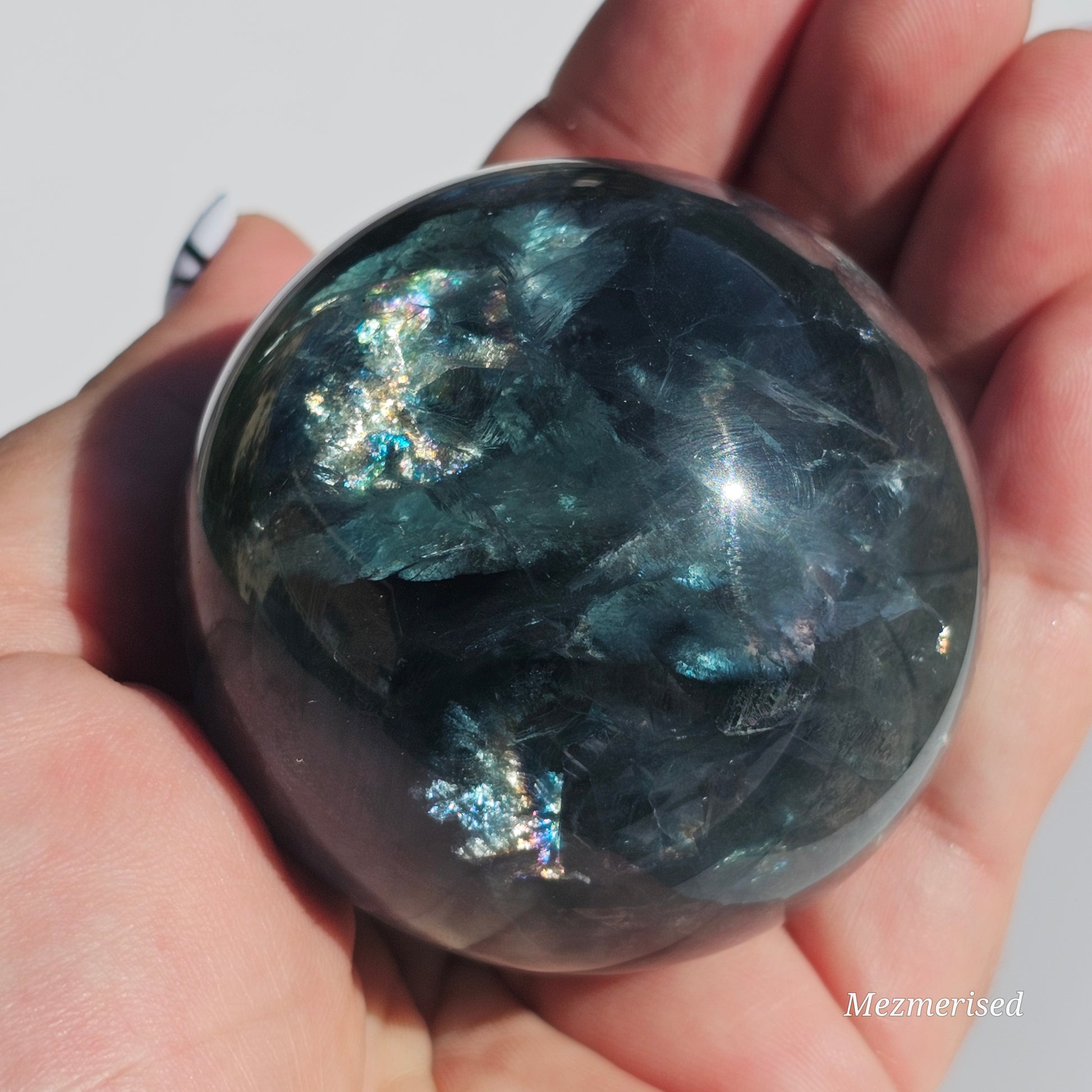 Rich dark forest green Fluorite sphere with beautiful rainbows