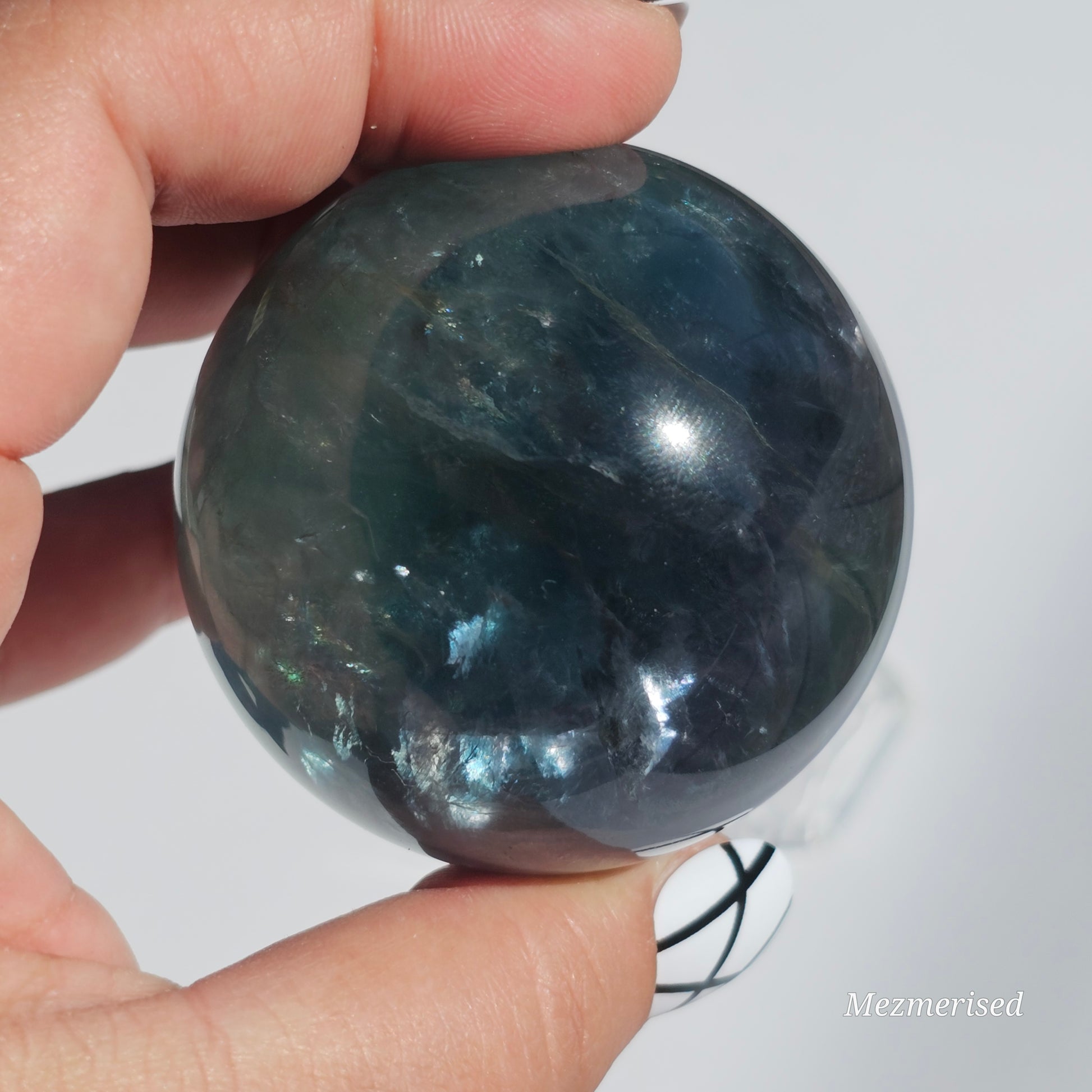 Rich dark forest green Fluorite sphere with beautiful rainbows