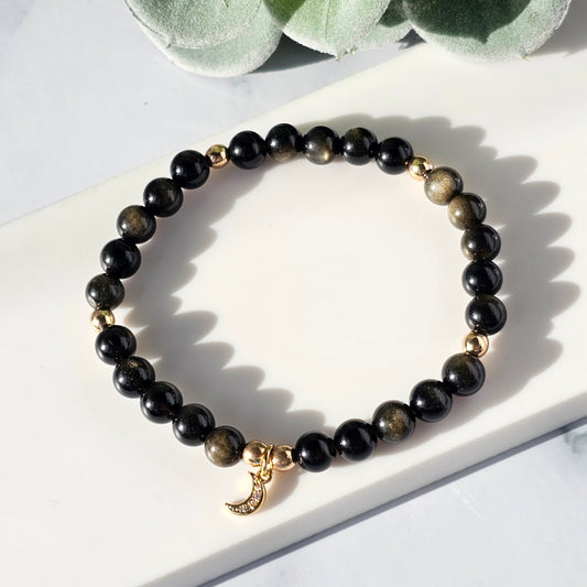 gold sheen obsidian bracelet with a crescent charm