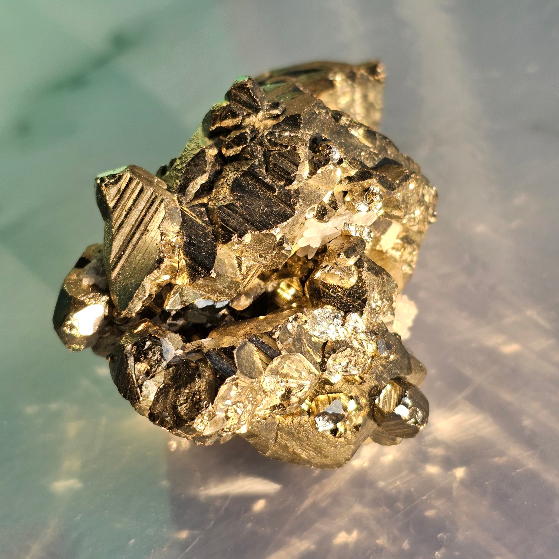 Natural Pyrite cluster in its raw form. This mineral displays a brilliant metallic lustre, with well-defined and sharp parallel striations.