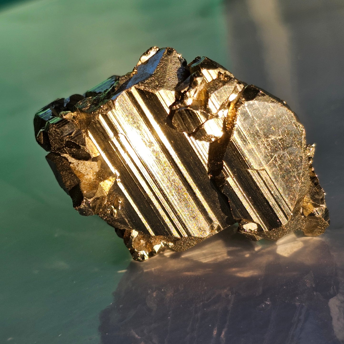 Natural Pyrite cluster in its raw form. This mineral displays a brilliant metallic lustre, with well-defined and sharp parallel striations.