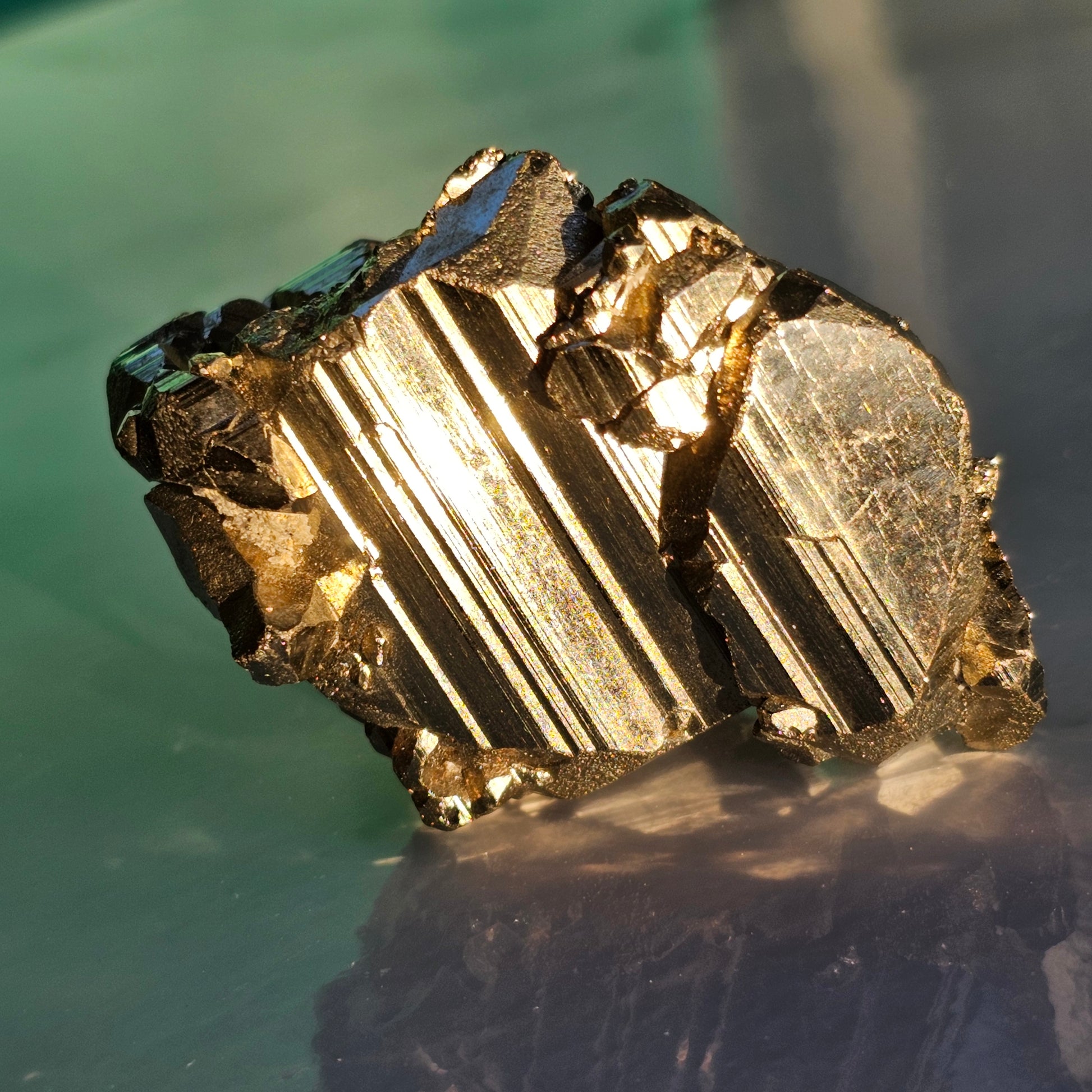 Natural Pyrite cluster in its raw form. This mineral displays a brilliant metallic lustre, with well-defined and sharp parallel striations.