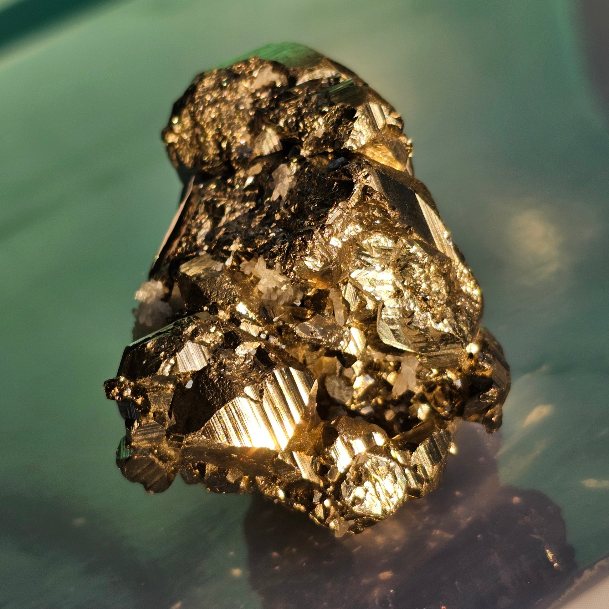 Natural Pyrite cluster in its raw form. This mineral displays a brilliant metallic lustre, with well-defined and sharp parallel striations.