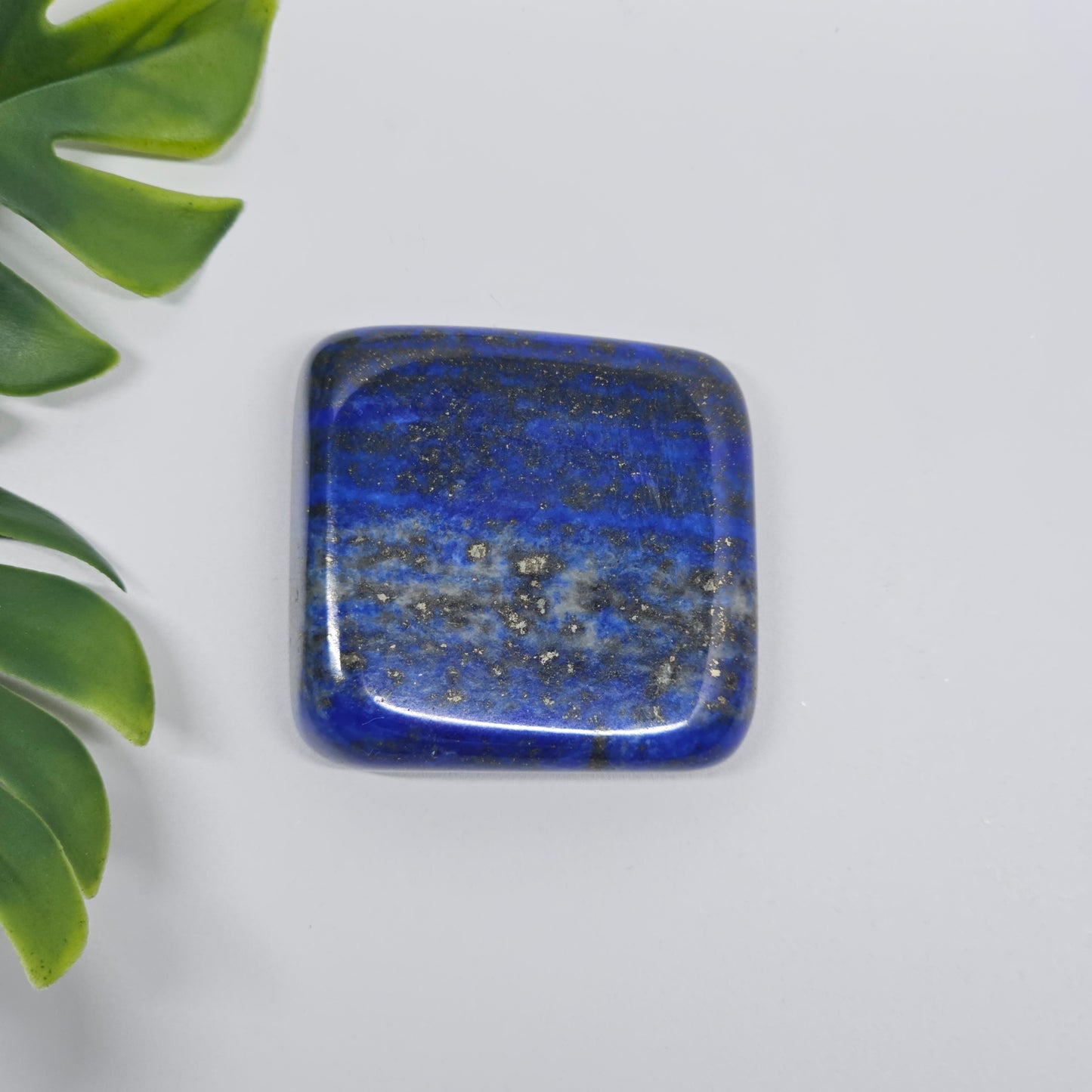 AA Grade Lapis Lazuli polished tumble stone with deep royal blue colour and natural Pyrite speckles. Premium quality crystal available in Australia.