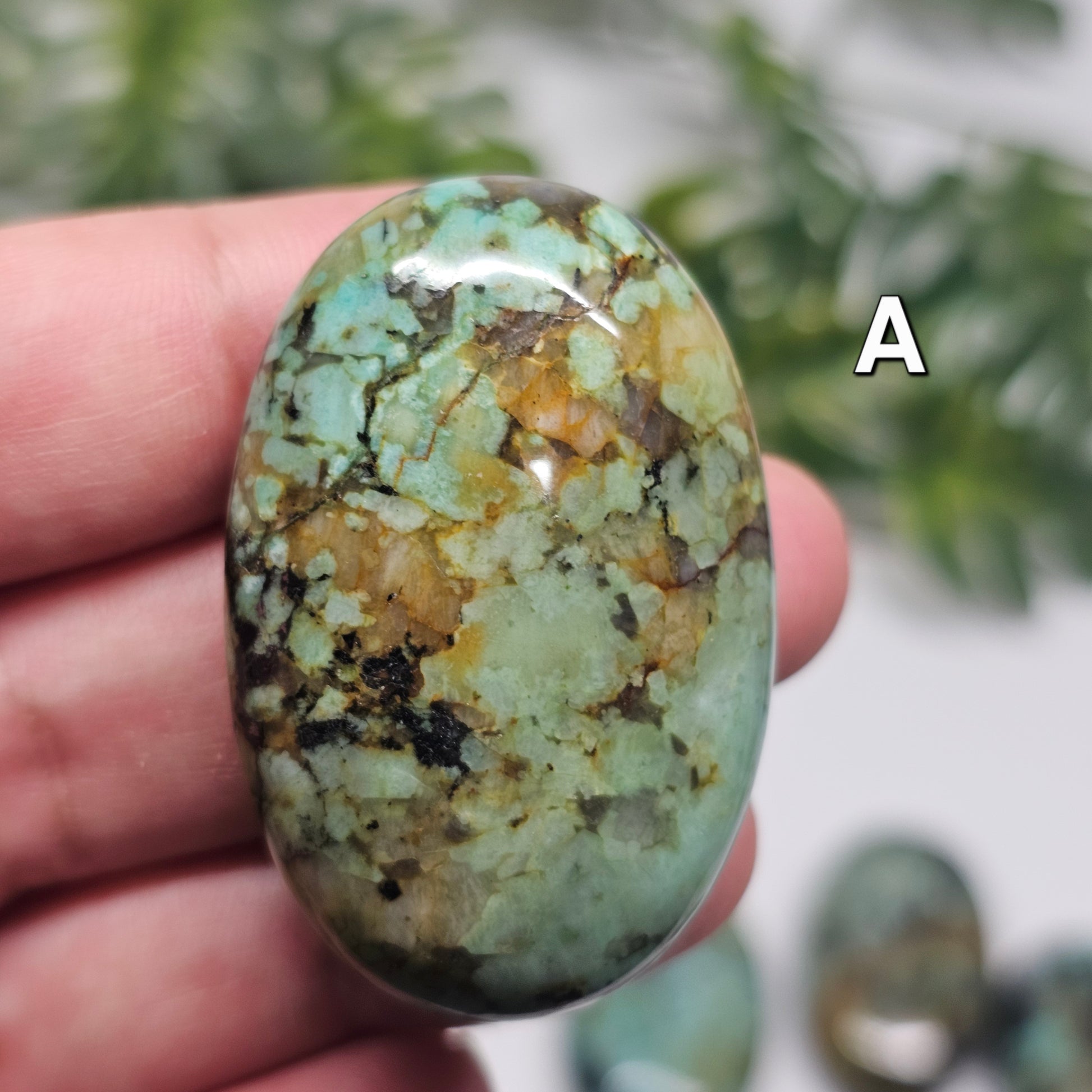 Front view of African Turquoise Palm Stone A, displaying its polished surface, natural patterning, and earthy green tones.