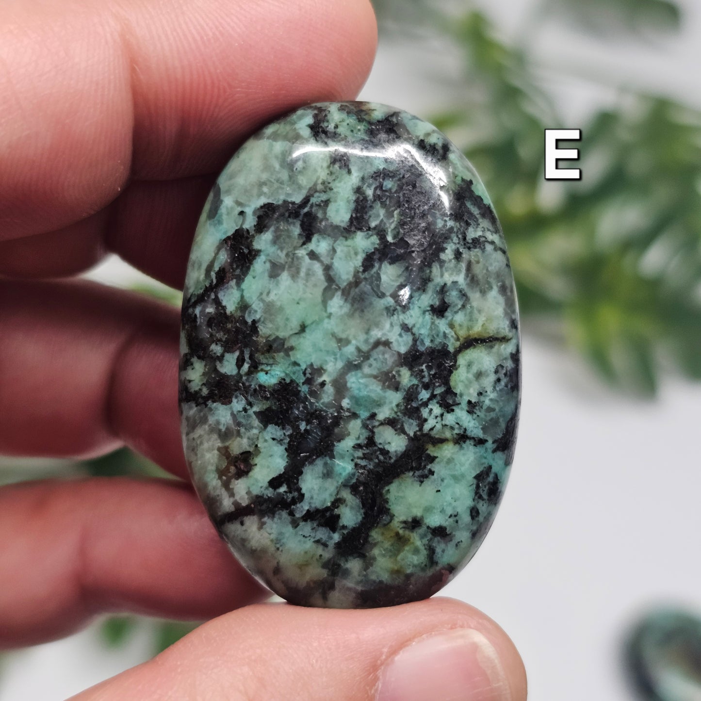 Front view of African Turquoise Palm Stone E, featuring earthy green tones and a smooth polished finish.