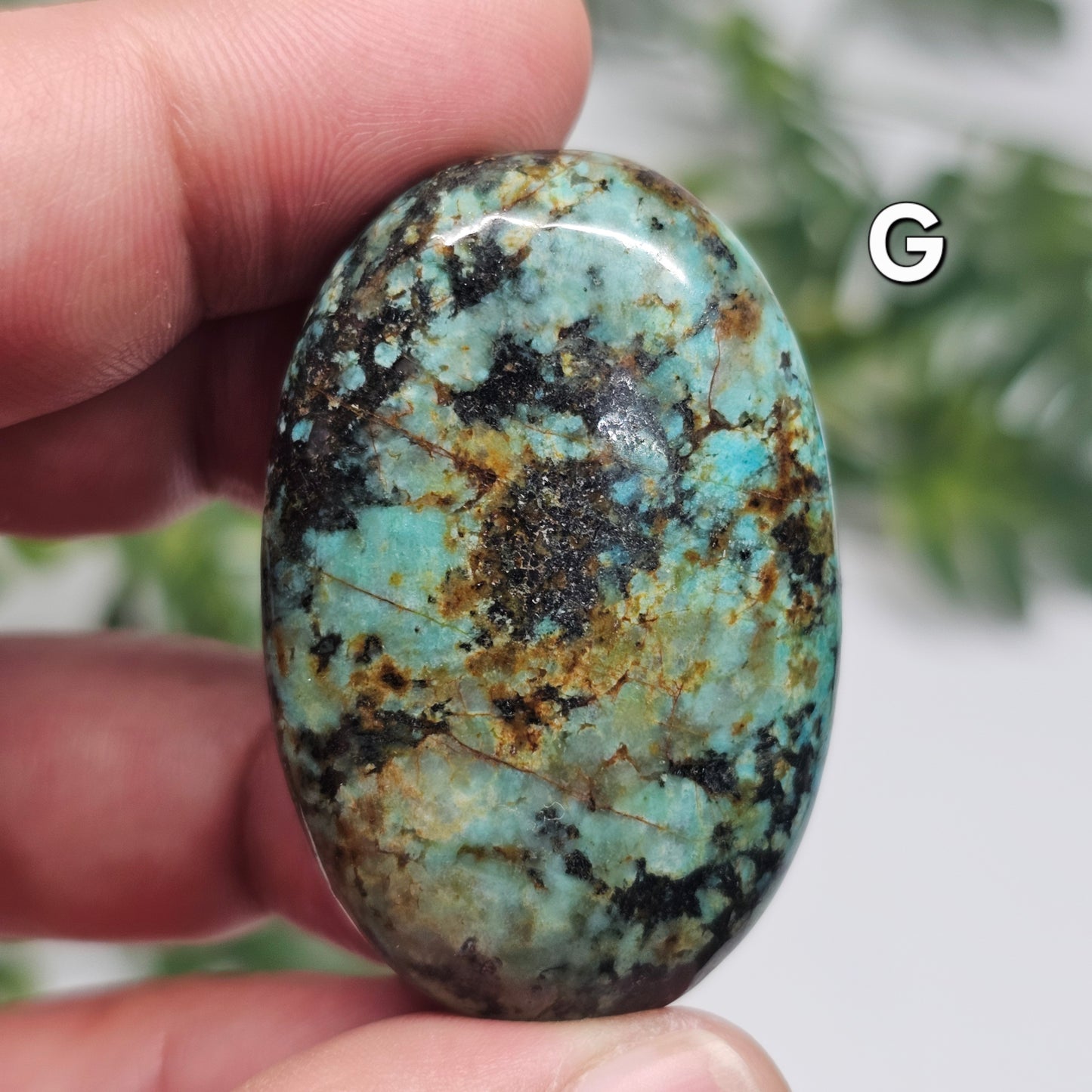 Front view of African Turquoise Palm Stone G, featuring natural green and black patterns with a polished finish.