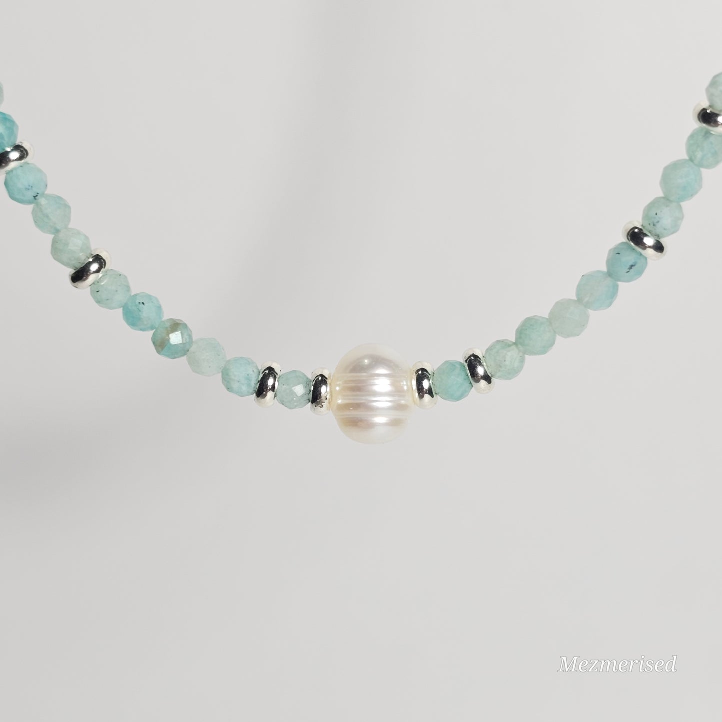 Close up of freshwater pearl focal on Amazonite necklace.