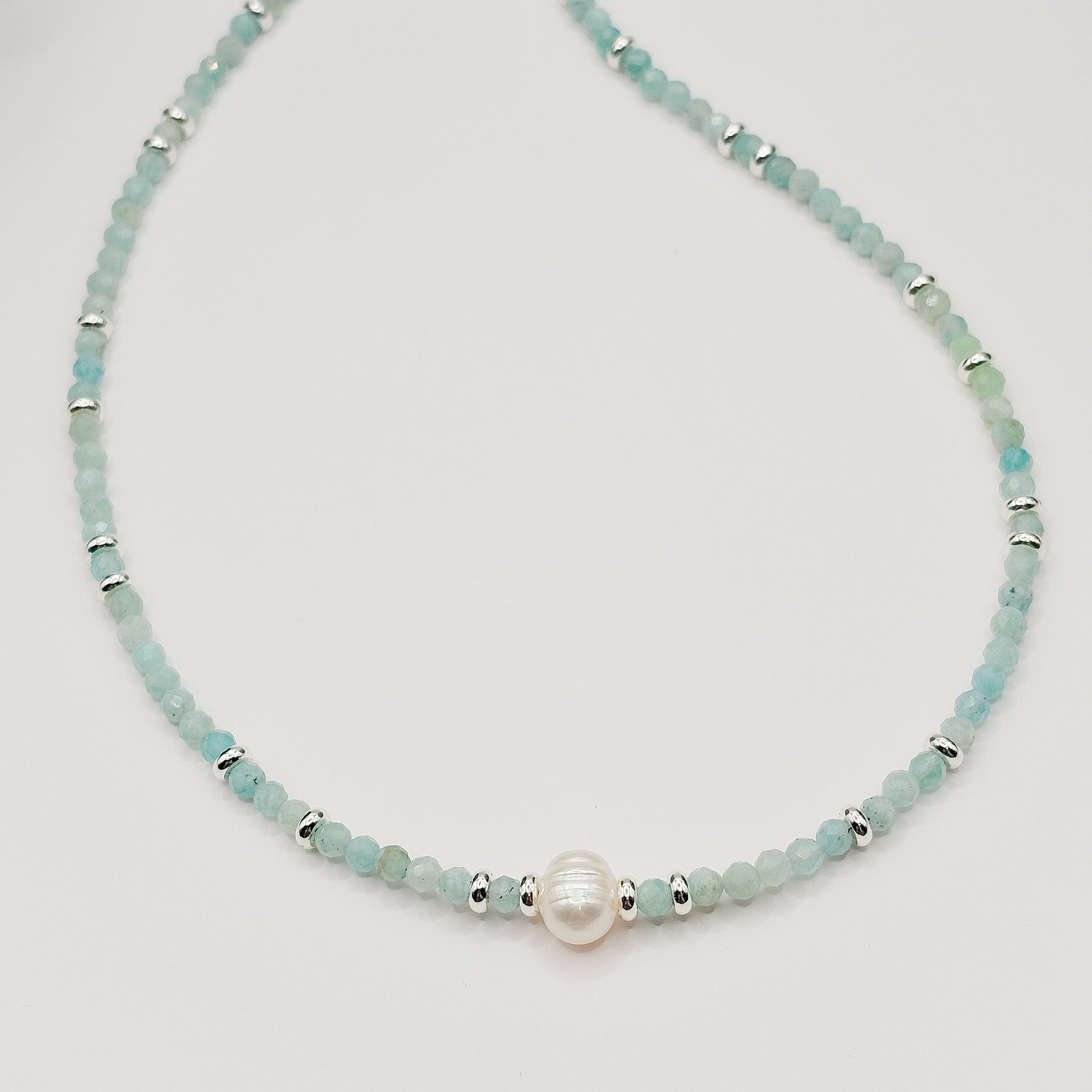 Close detail of Amazonite beads and pearl section laying flat.