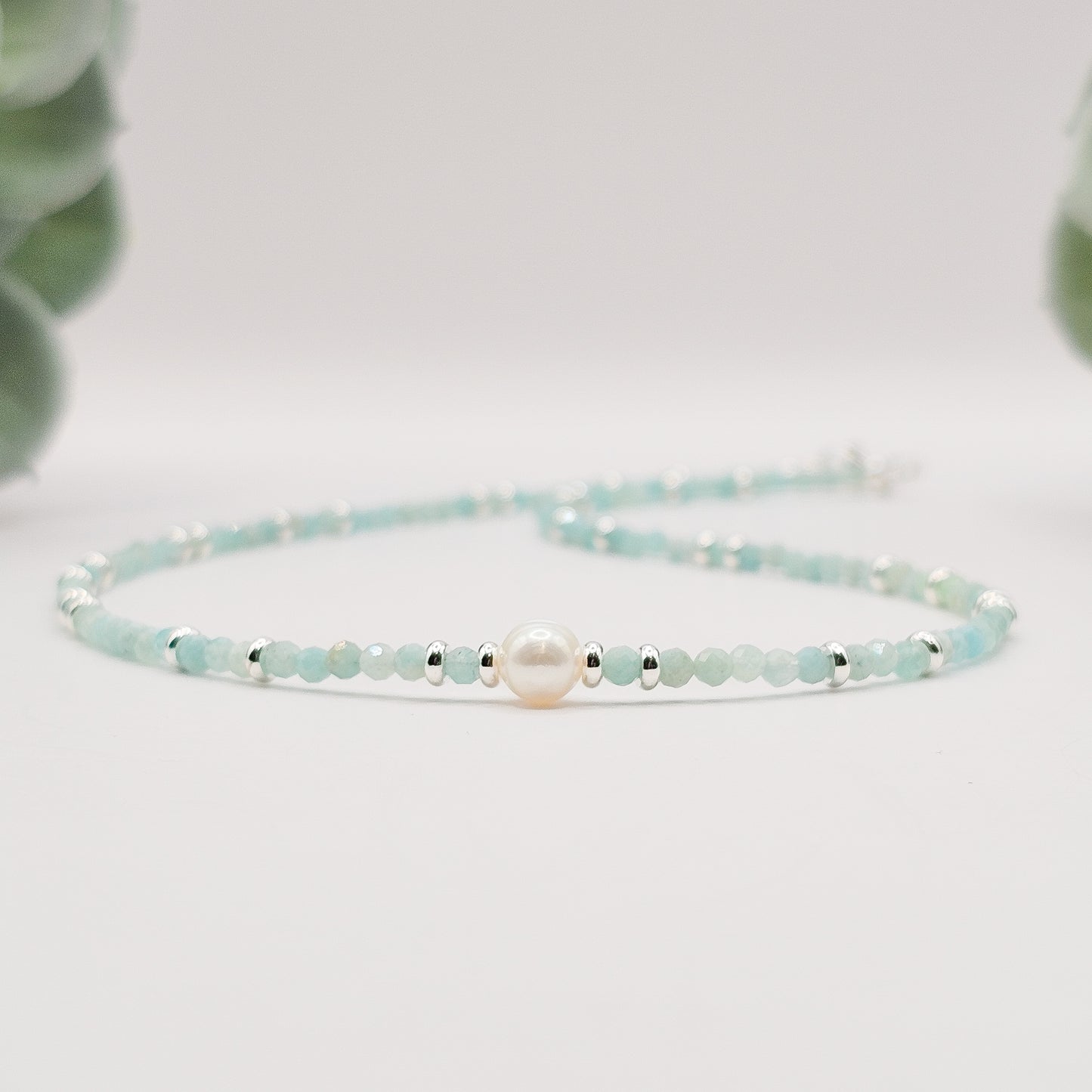 Front angled view of Amazonite pearl necklace laid flat.
