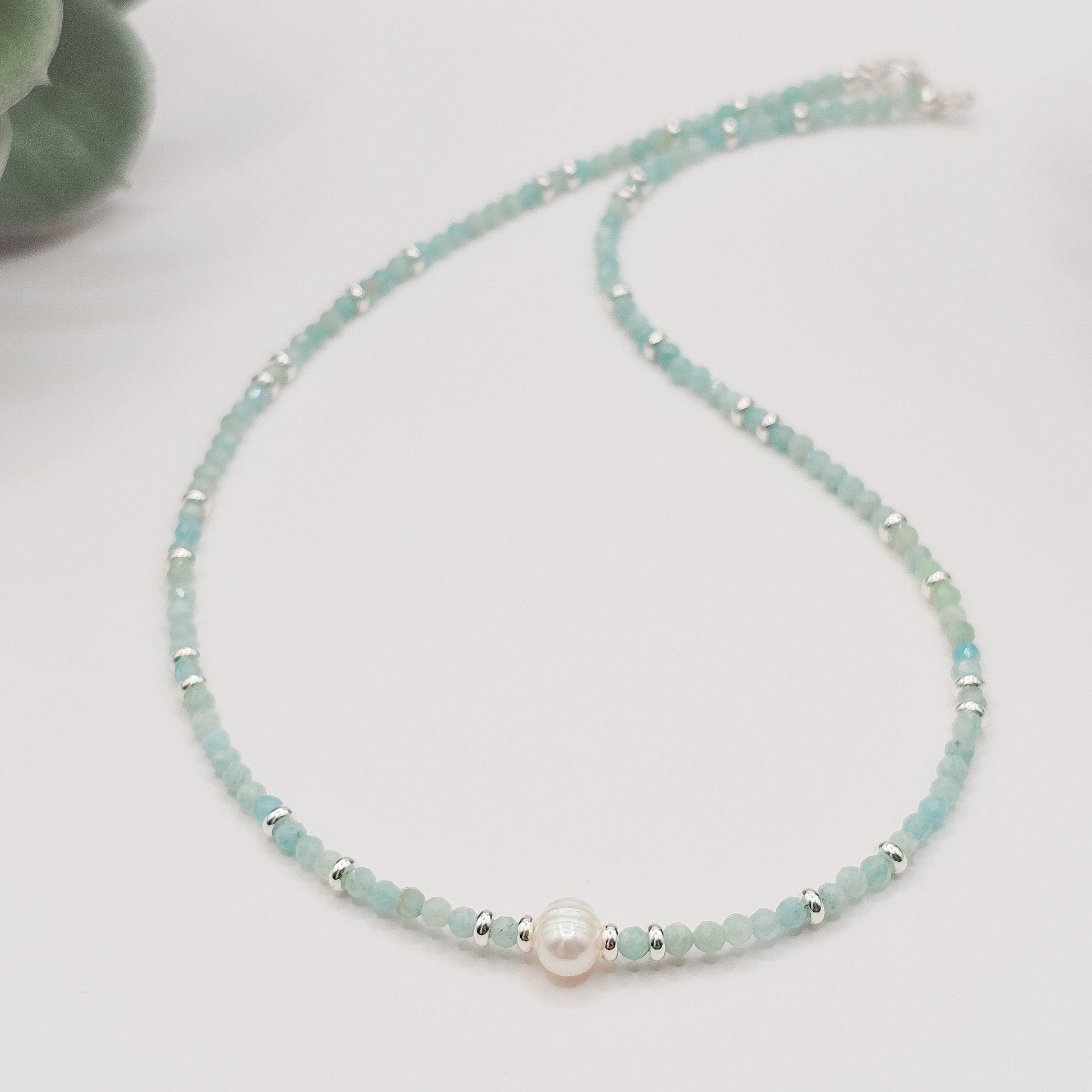 Amazonite and pearl necklace laid flat.