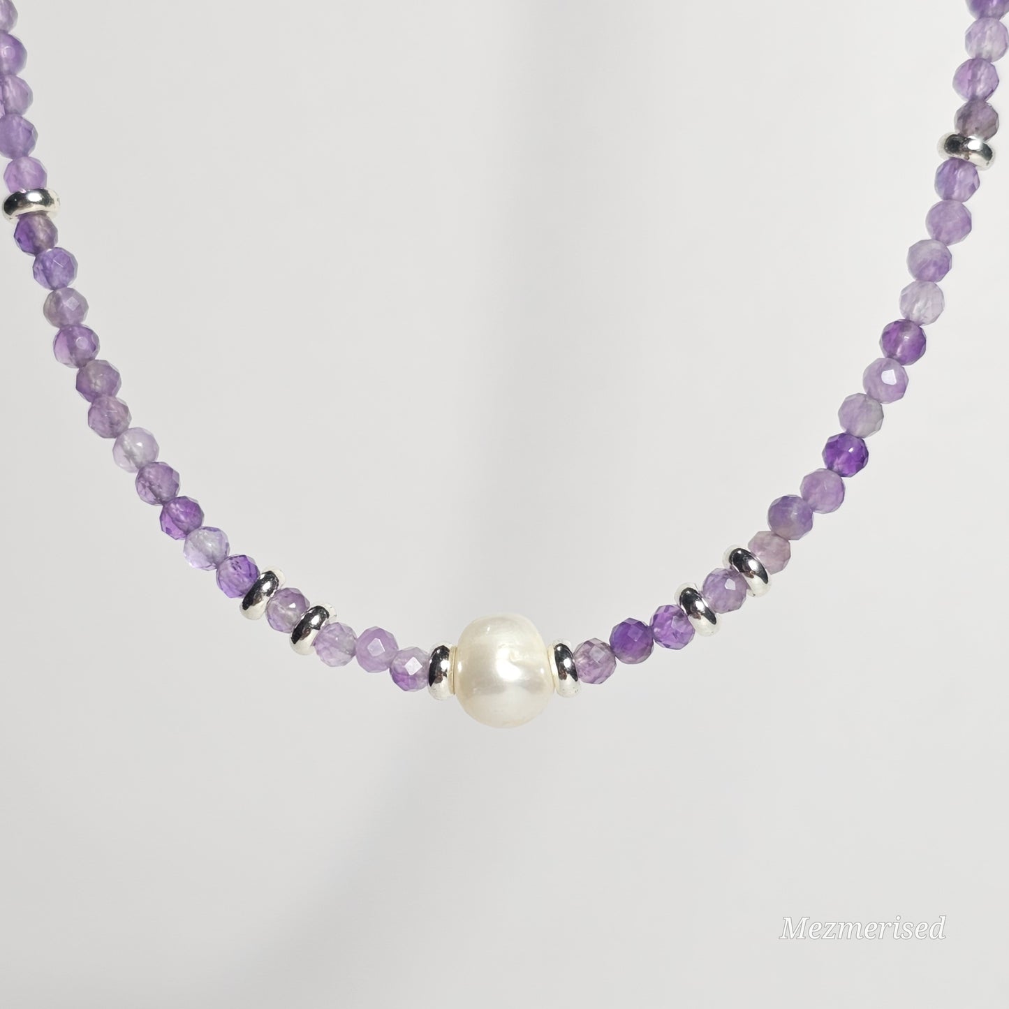 Front view of Amethyst and pearl necklace hanging.
