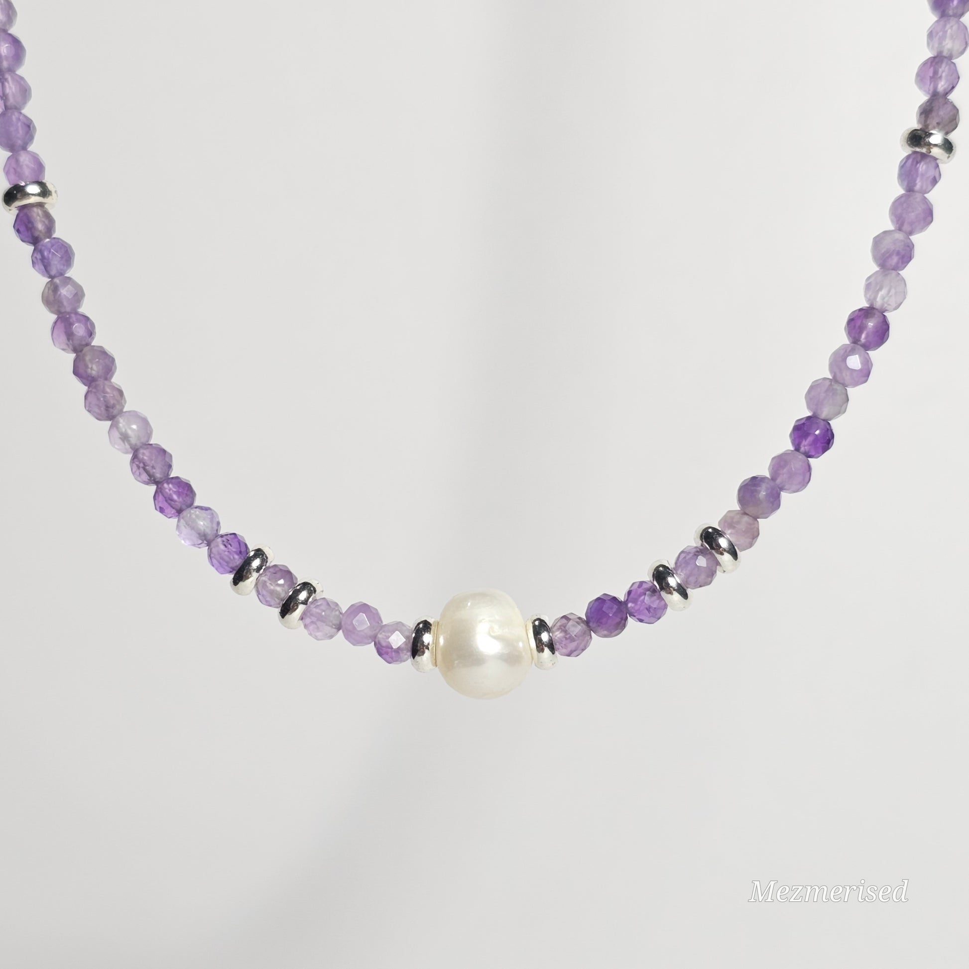 Front view of Amethyst and pearl necklace hanging.