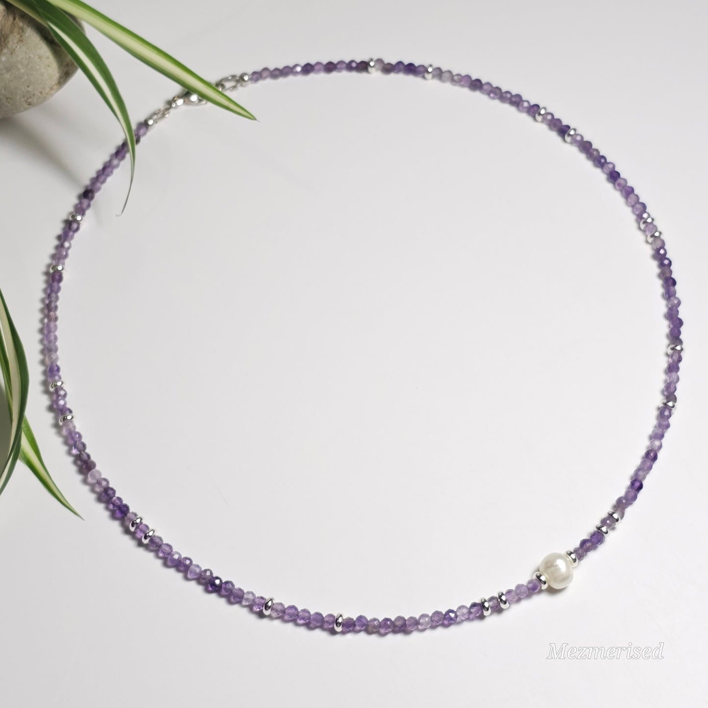 Full view of Amethyst and freshwater pearl necklace laid in a circle.