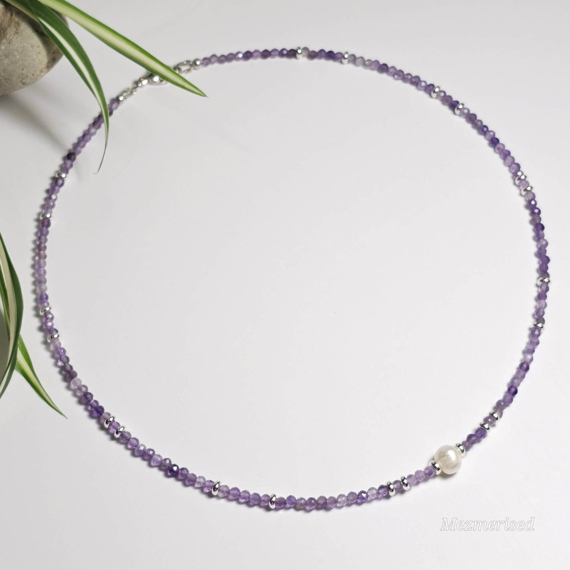 Full view of Amethyst and freshwater pearl necklace laid in a circle.