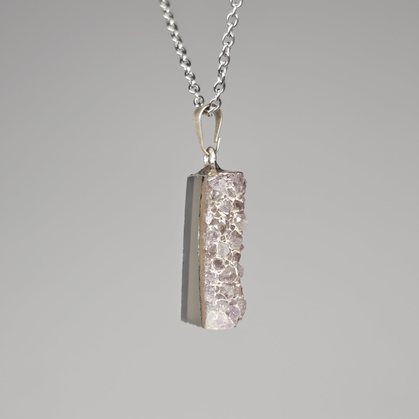 Silver plated gemstone pendant with Amethyst points.
