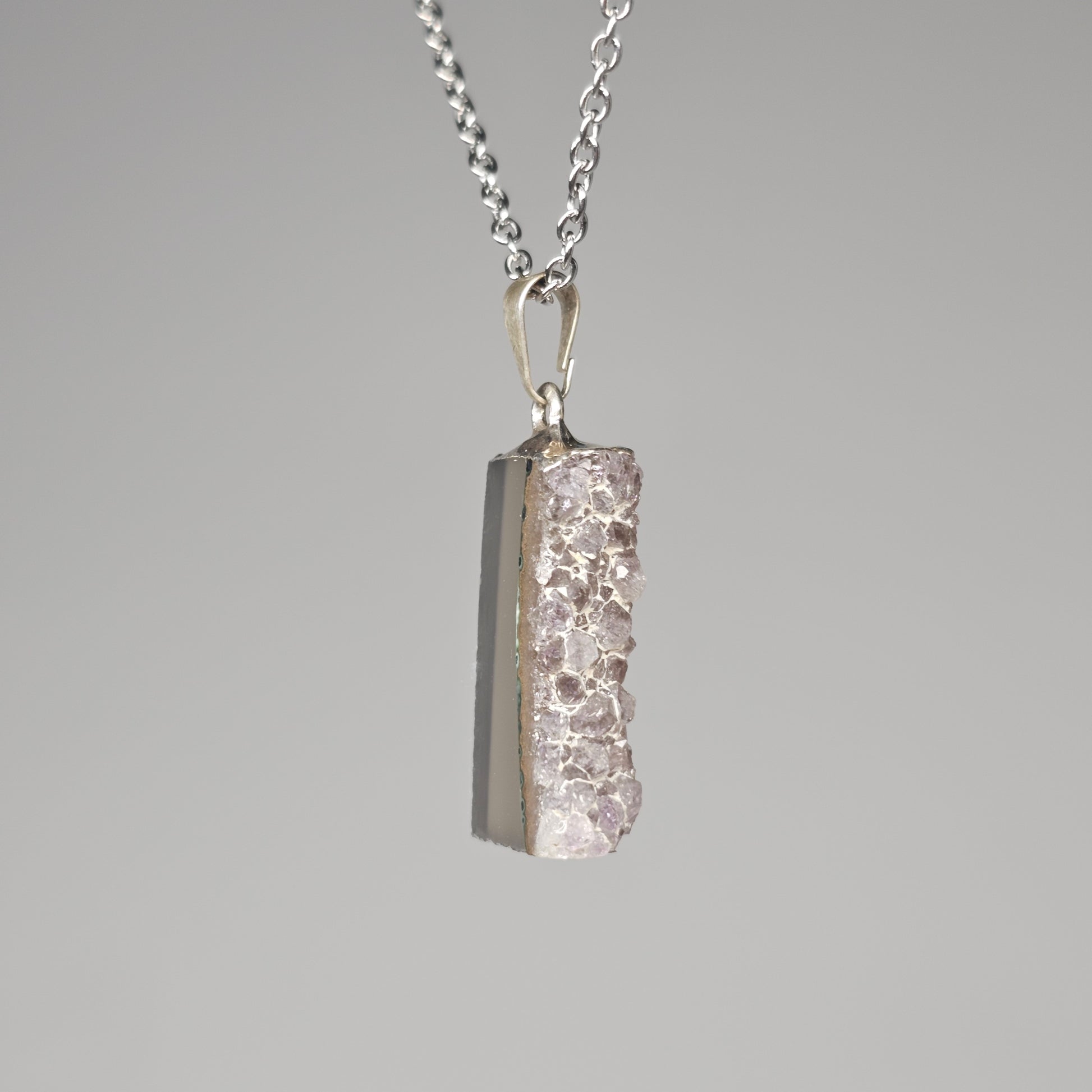 Silver plated gemstone pendant with Amethyst points.