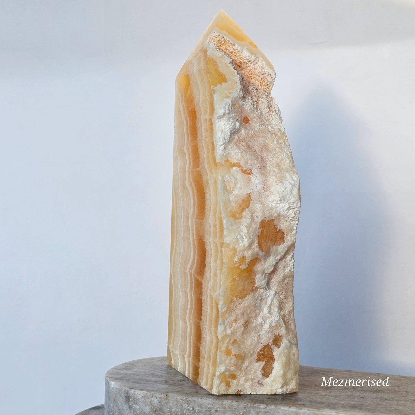 A side view featuring the rugged, matte white chalky matrix providing a natural contrast to the polished crystal faces.
