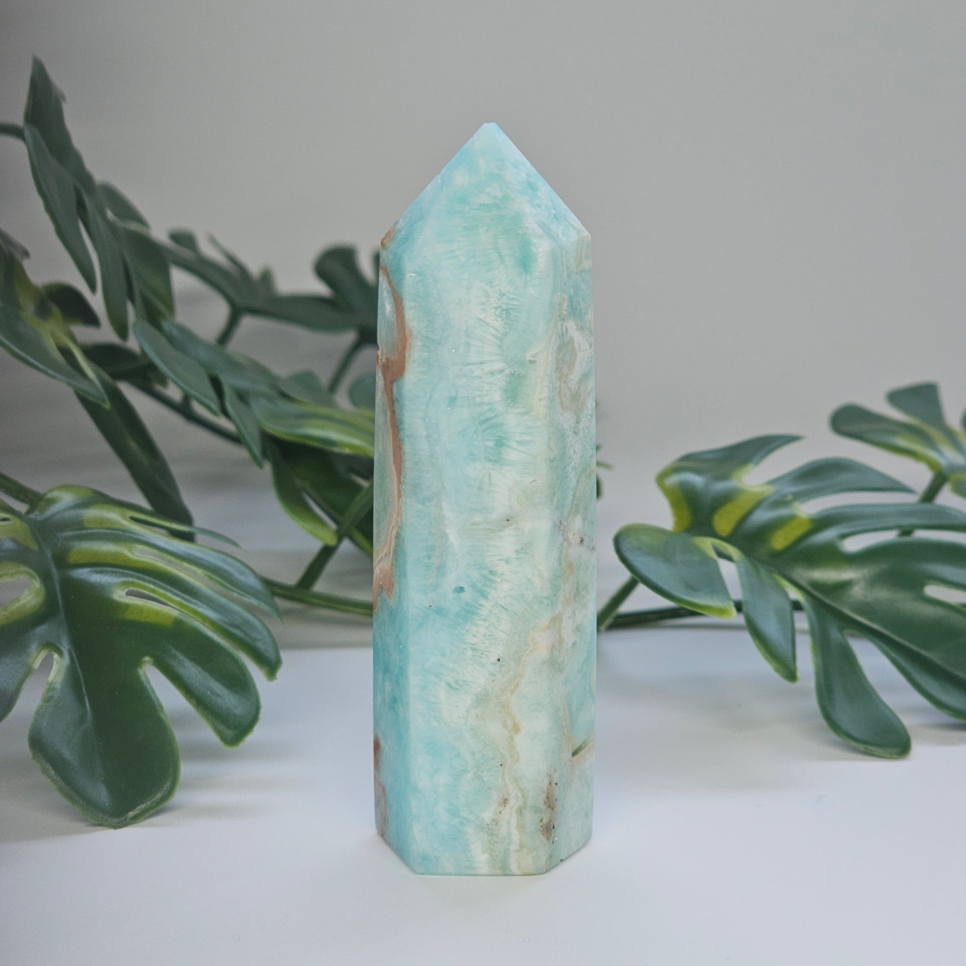 Angled view of Blue Aragonite tower highlighting ocean-like colouring and natural texture.