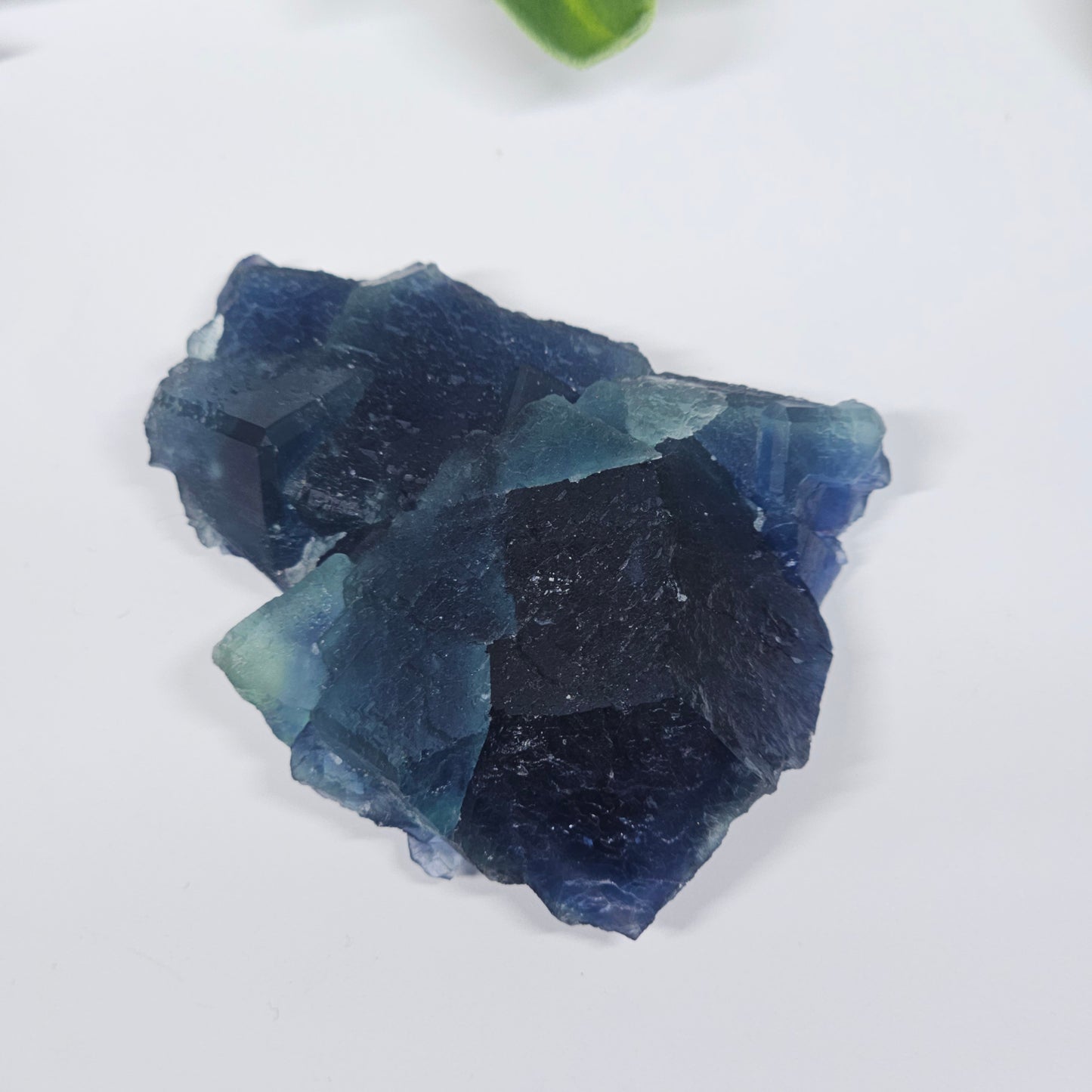 Alternate view of the raw Blue Fluorite specimen highlighting its stepped crystal structure and colour zoning.