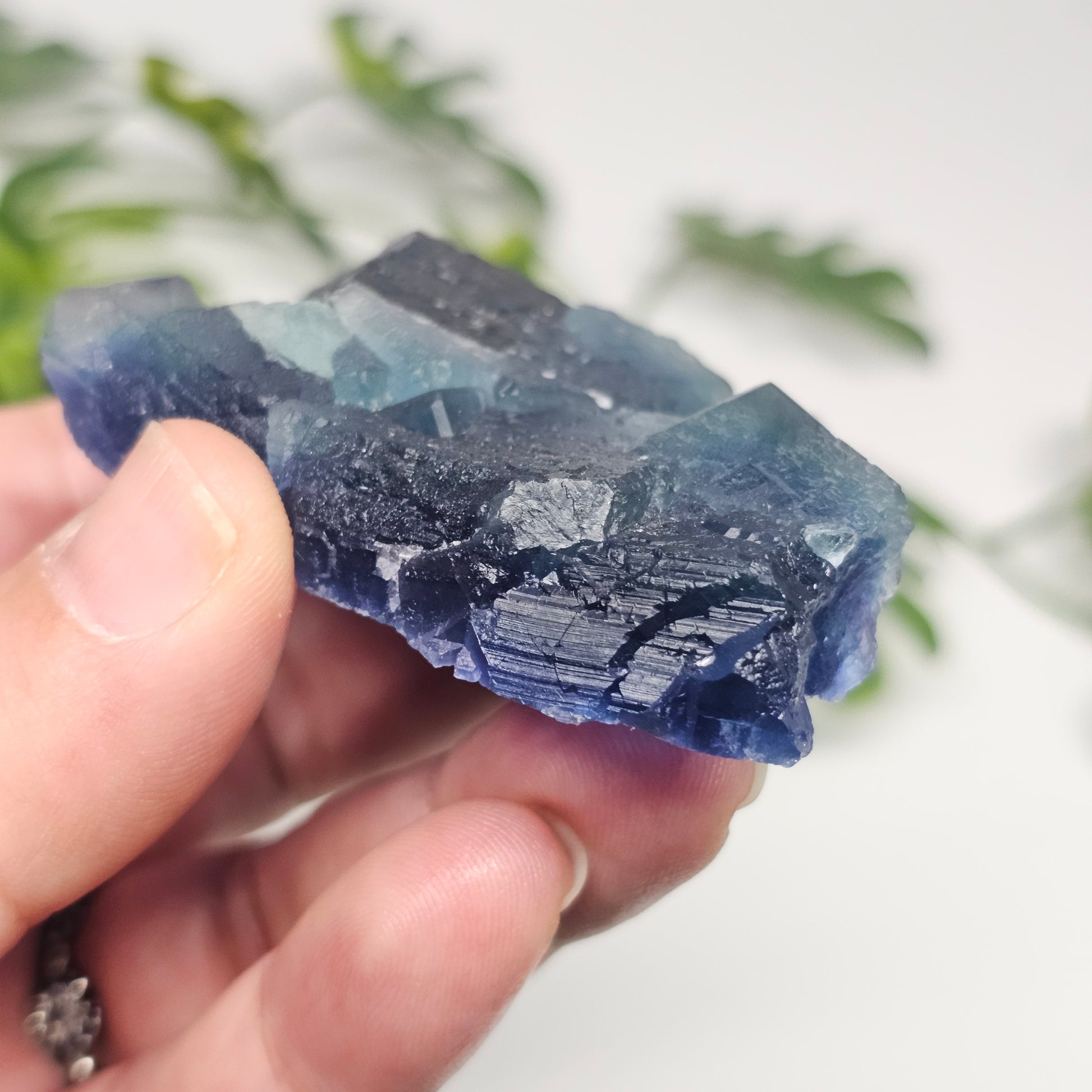 Different side view showing the natural crystal faces and layered growth of this raw Blue Fluorite specimen.