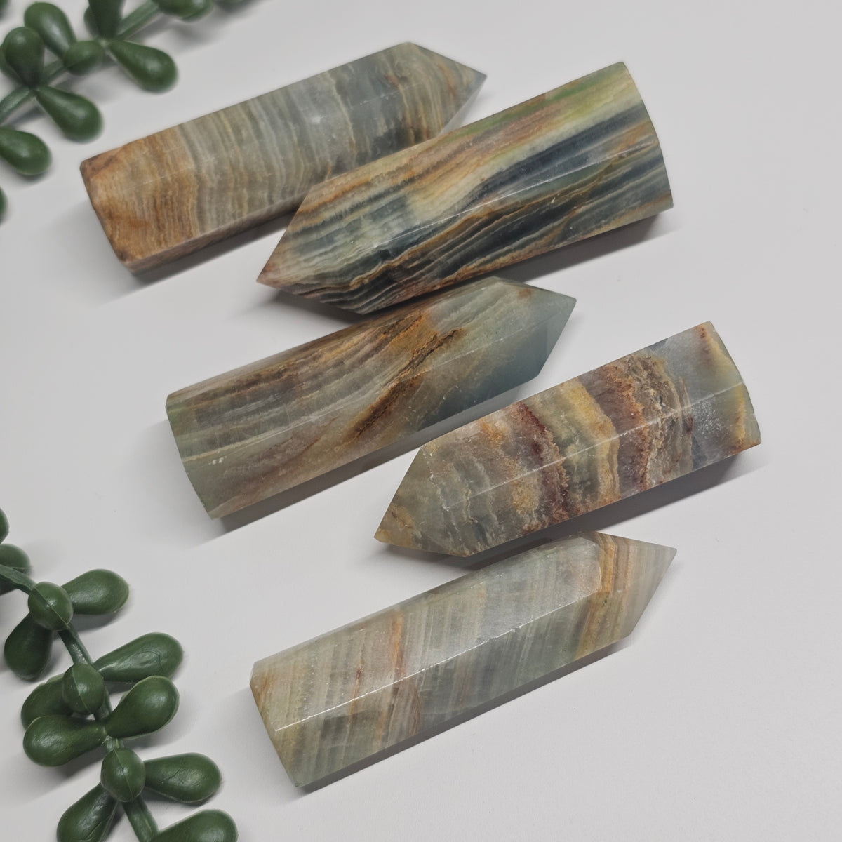 Banded Blue Onyx towers laid flat on a white surface