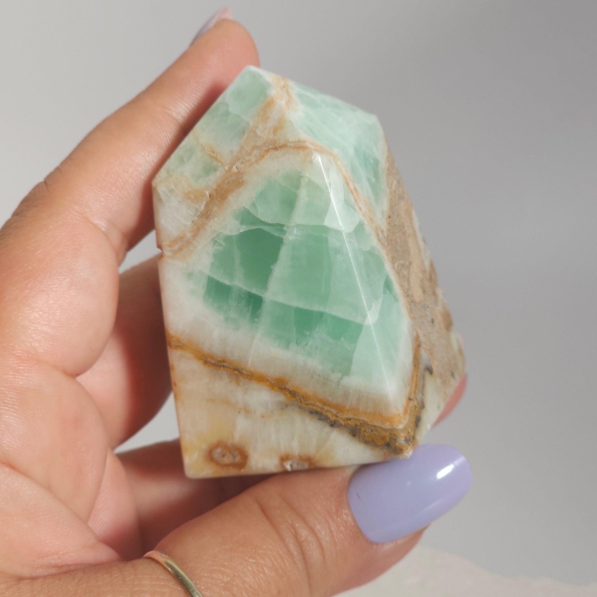 Caribbean Calcite Tower In Hand Close Up Showing Ocean Tones and Texture