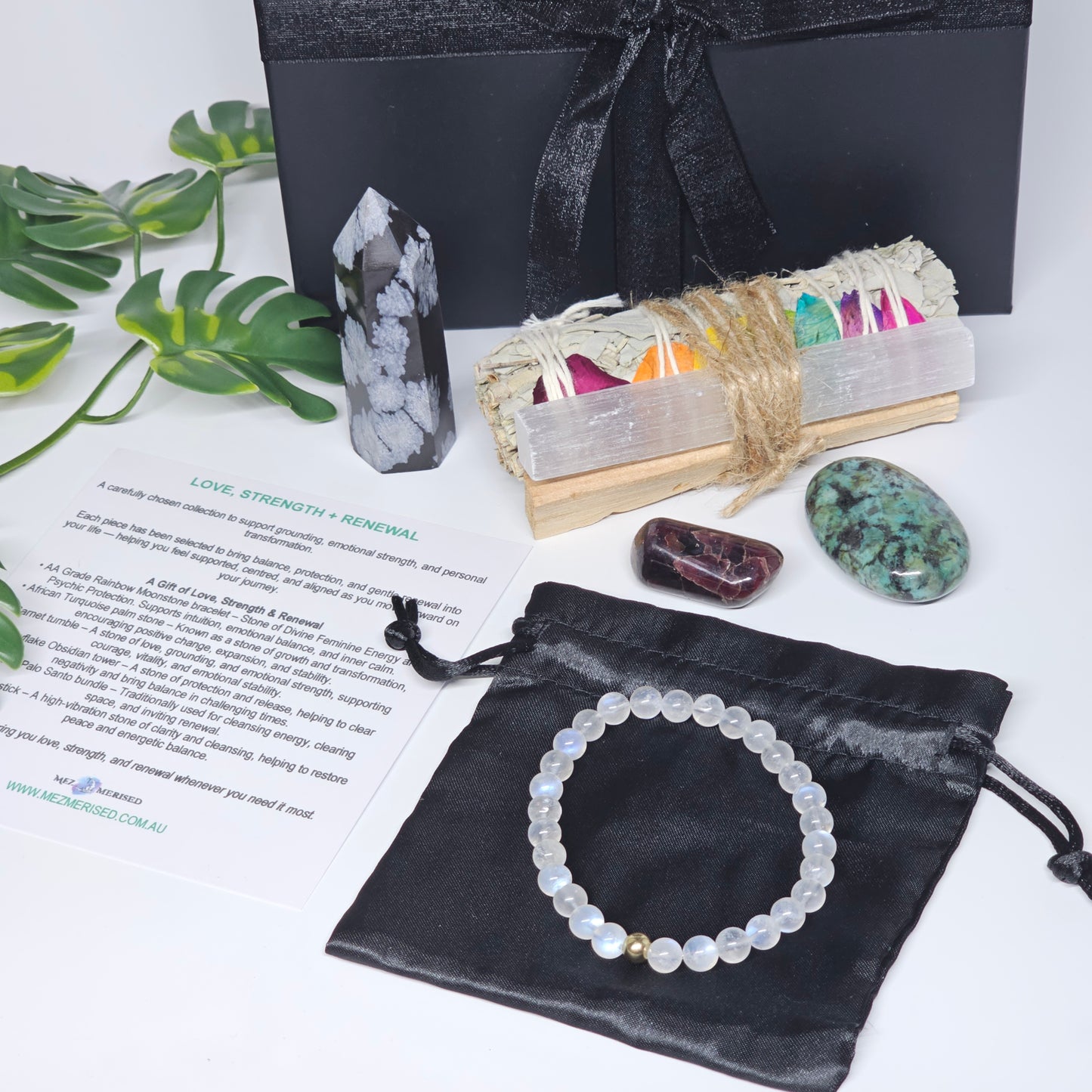 Crystal gift box set with all items laid out, including bracelet, crystals, cleansing tools and info card.