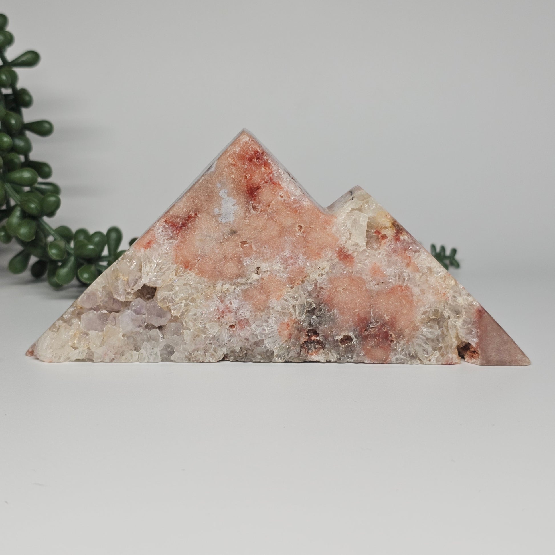A 399g freestanding mountain carving featuring deep red-toned Pink Amethyst with sparkling sugar druzy and purple Amethyst clusters.