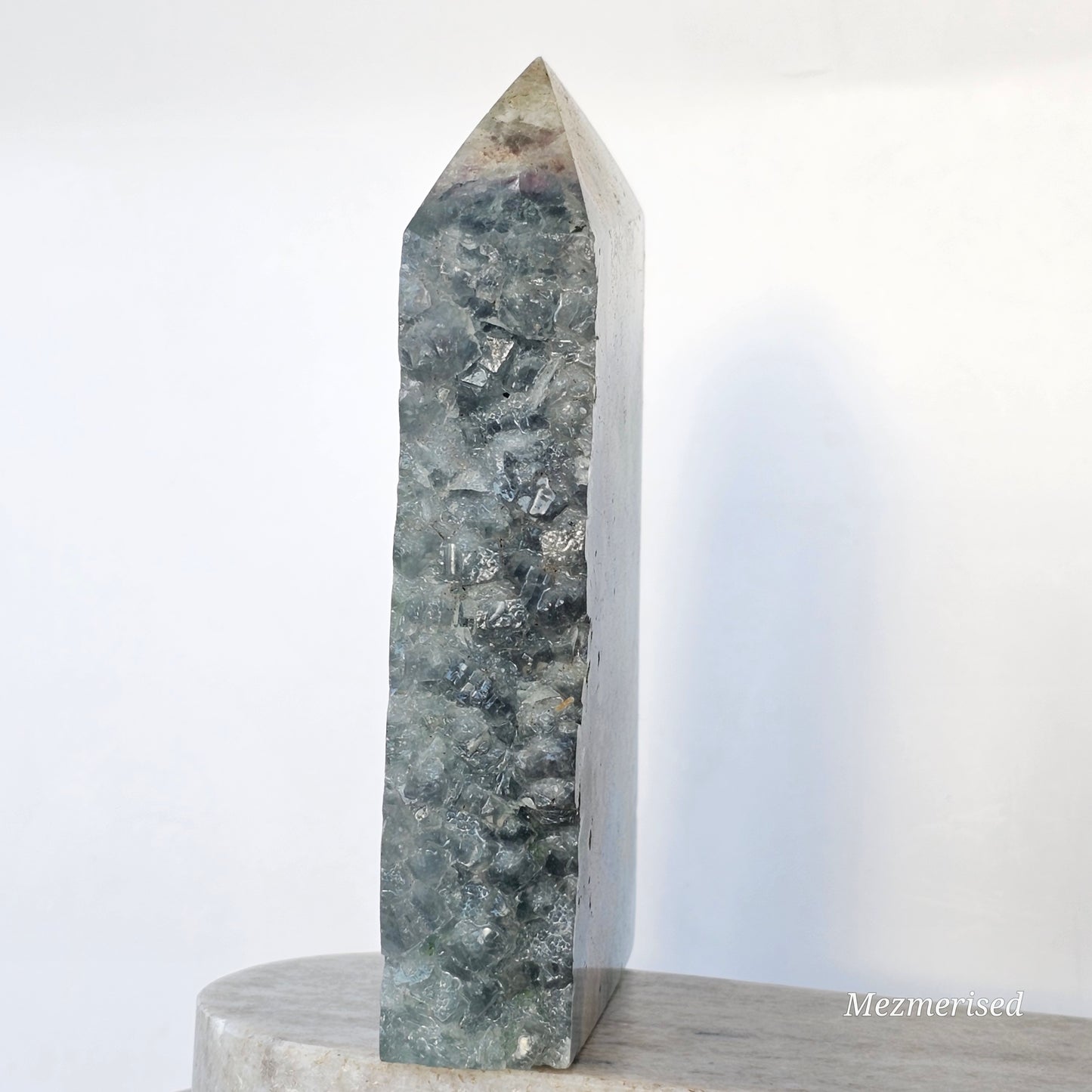 Side view of Feather Fluorite tower featuring natural druzy edge with raw crystal texture and sparkle.