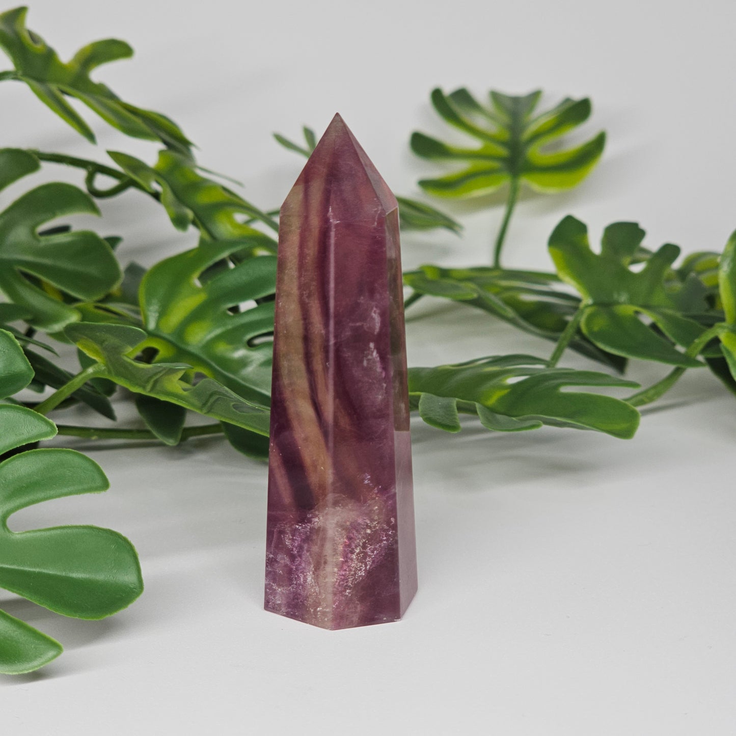 Fluorite tower detail with rich purple and yellow tones highlighting natural patterns and clarity