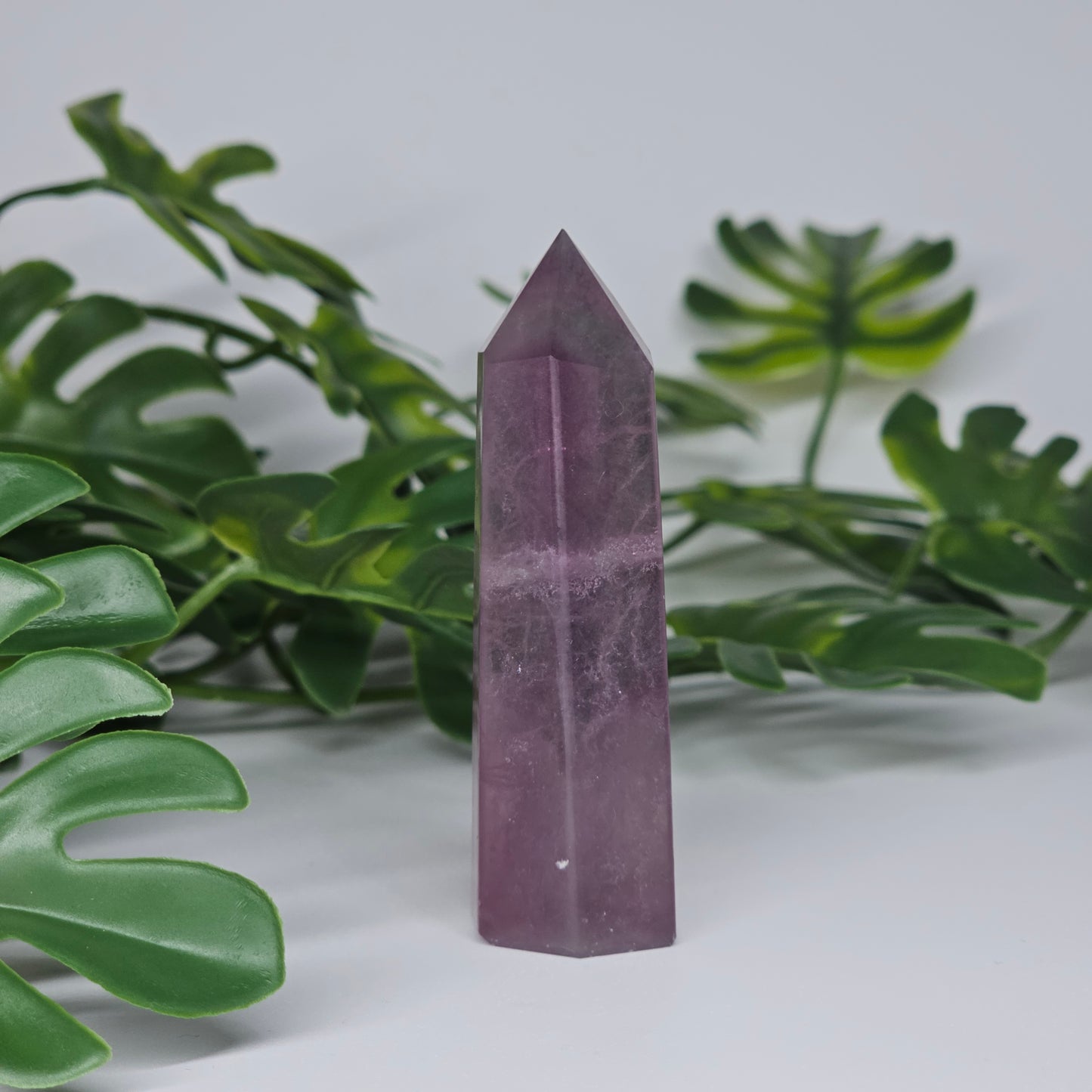 Fluorite crystal tower side profile showing purple tones and polished finish