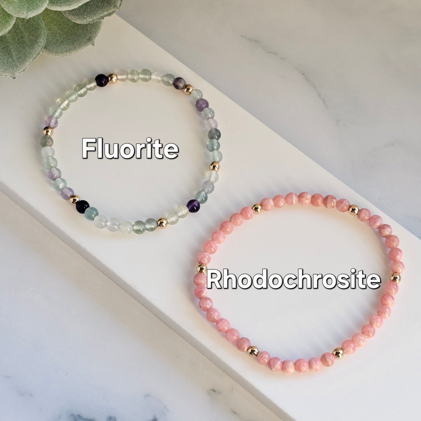 Minimal 4mm Fluorite and Rhodochrosite bracelets with gold accents styled in flat lay display.