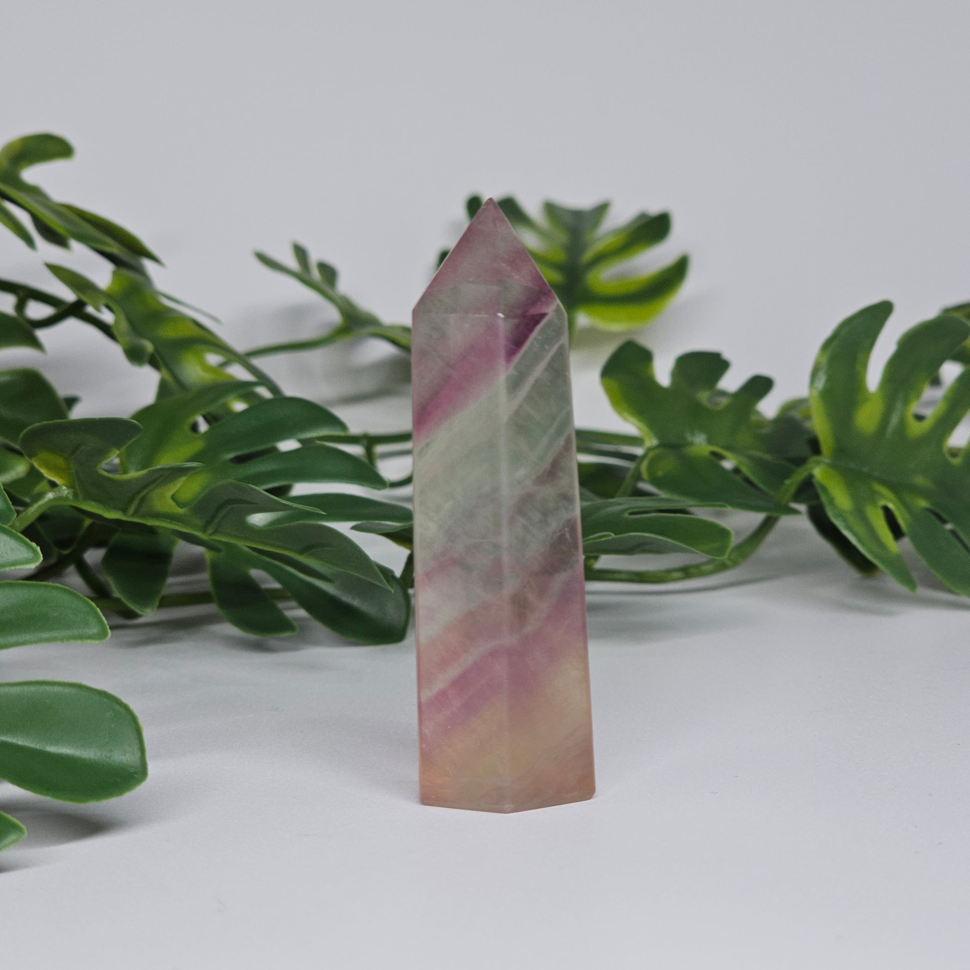Fluorite tower with mixed colour banding in purple, green and yellow with smooth polished surface
